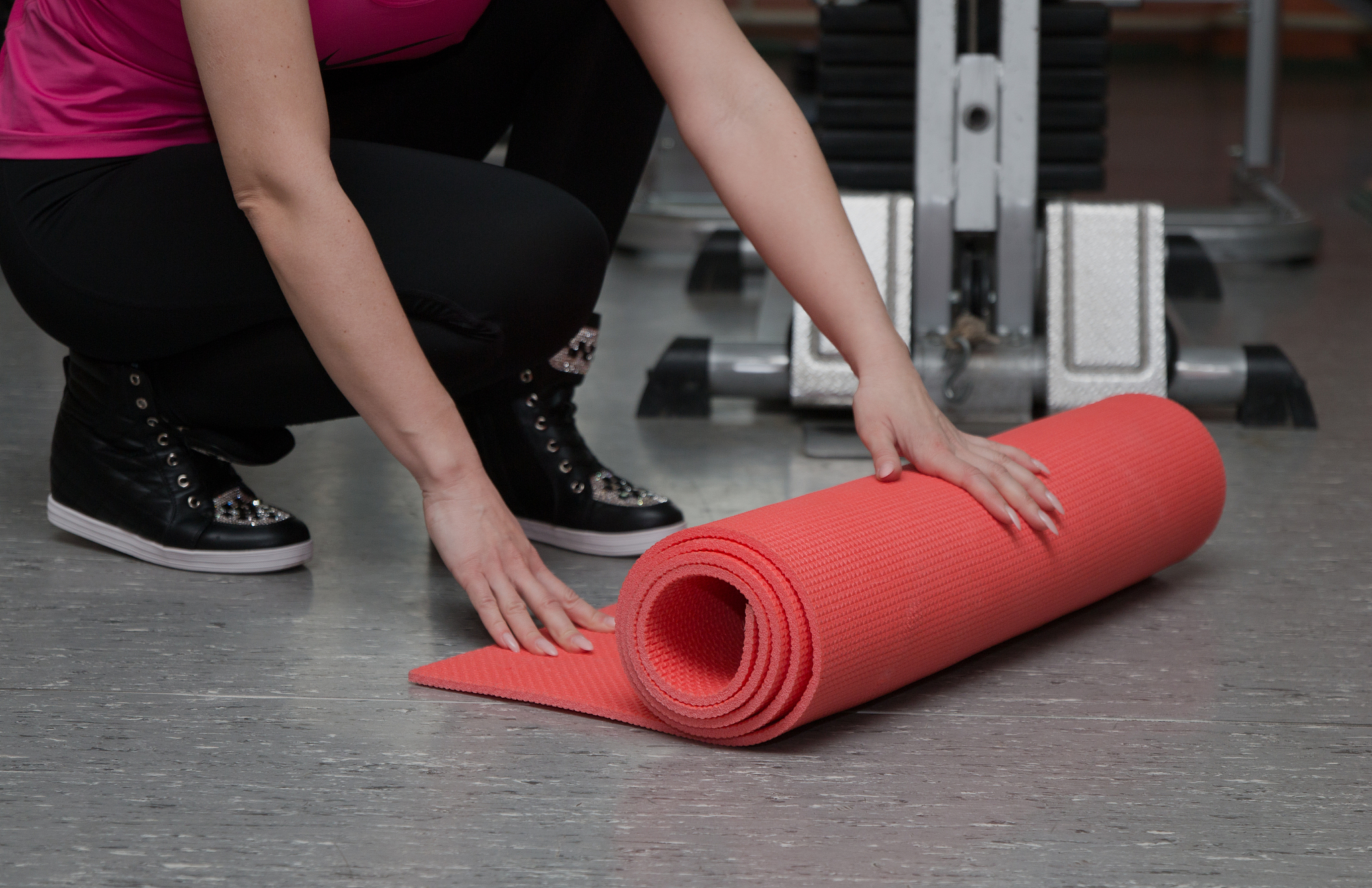 beautiful girl exercising in a fitness club on the rug