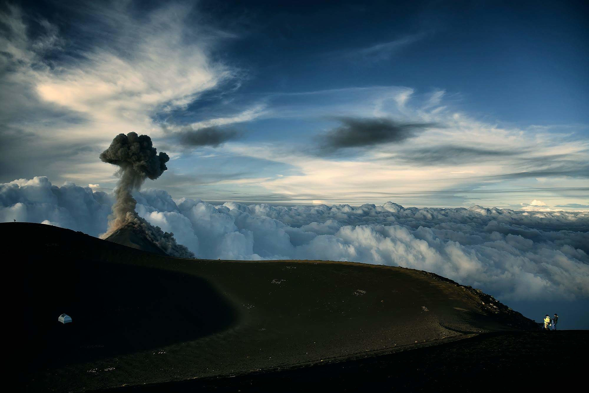 scenic view of volcanic mountain against sky