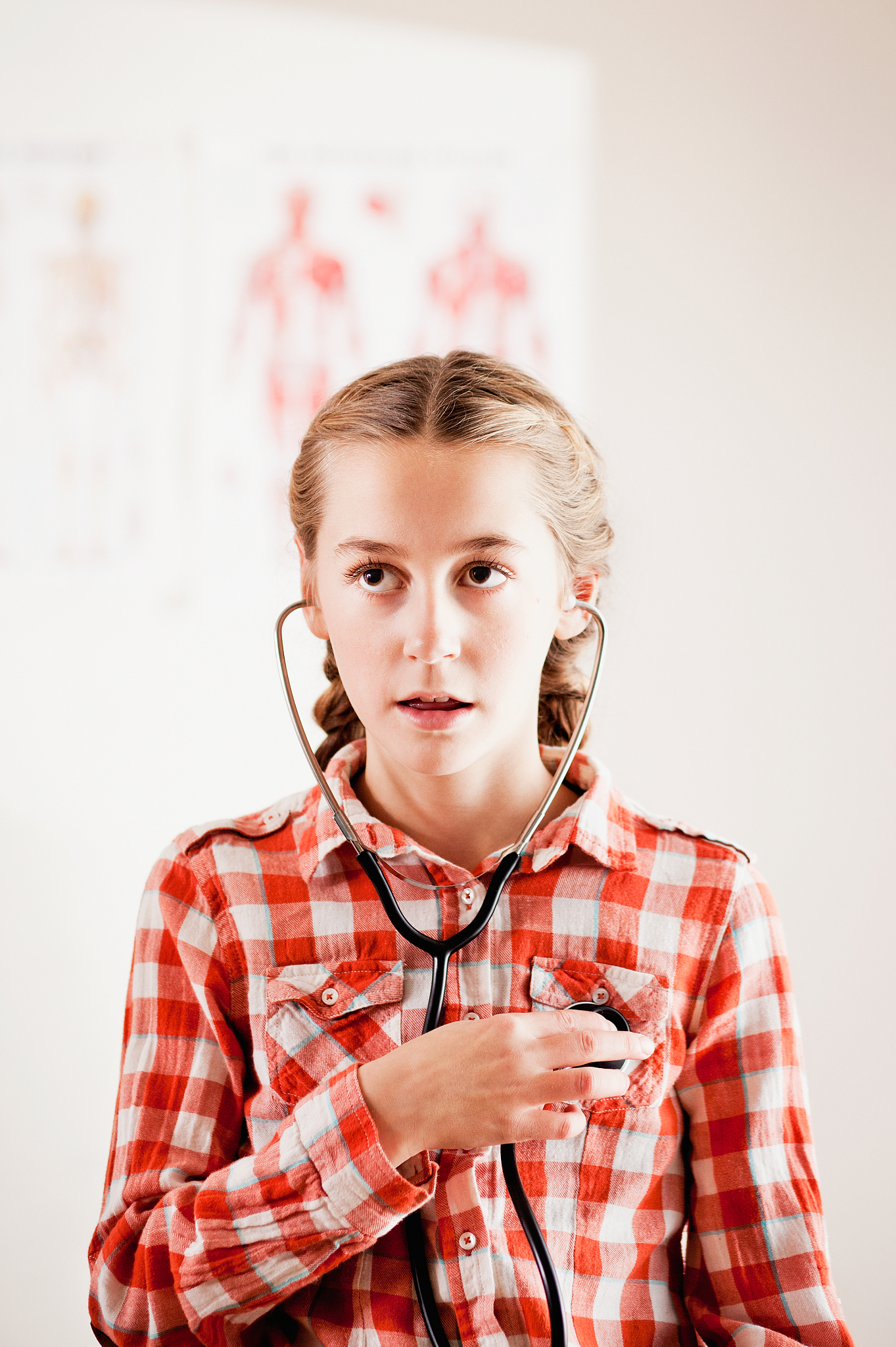 young girl listening to her heart with stethoscope