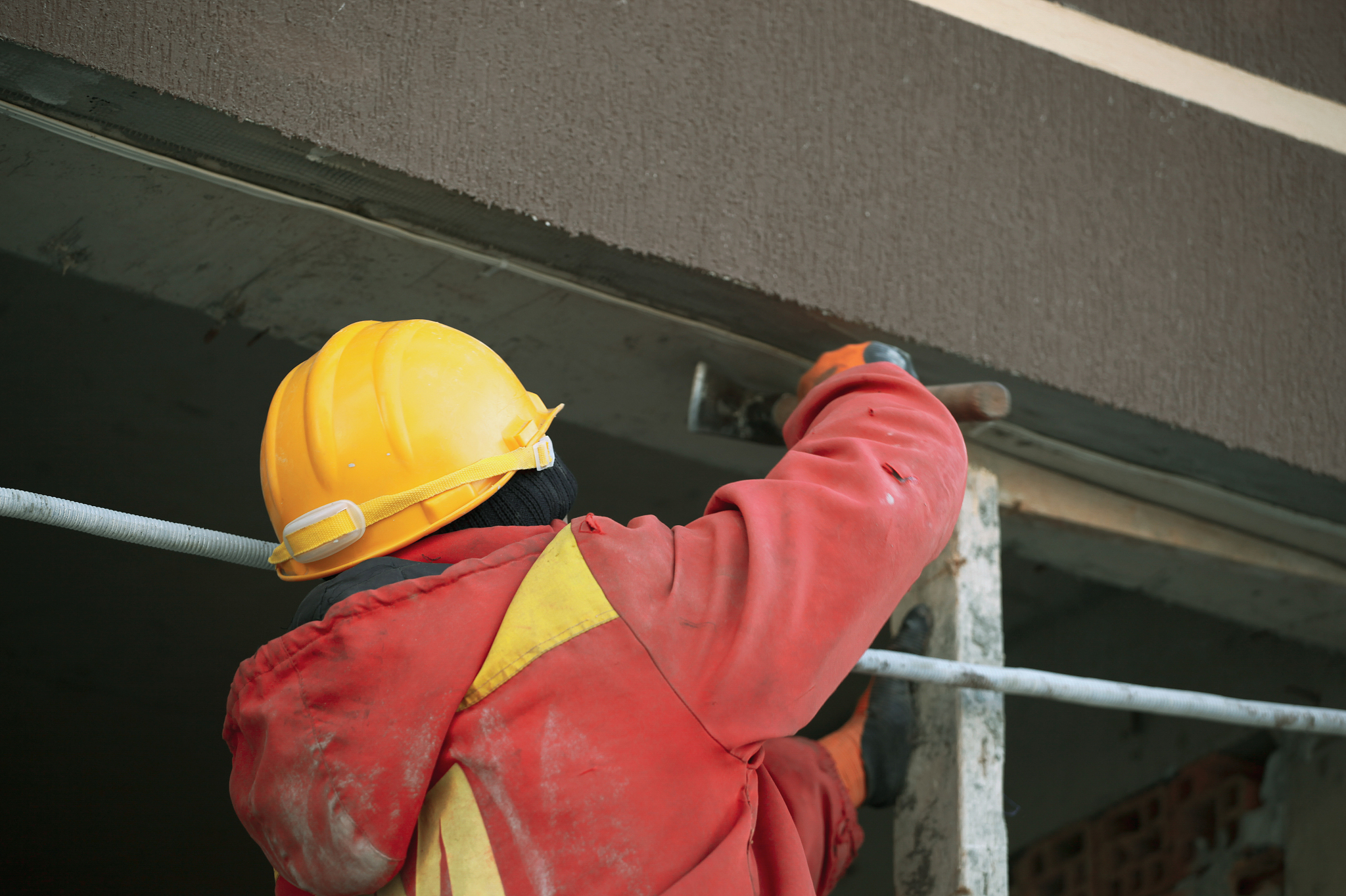 industrial bricklayer installing bricks on construction site