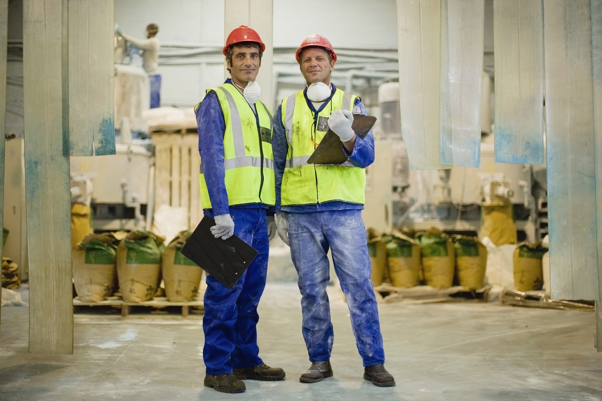 workers with masks standing in factory