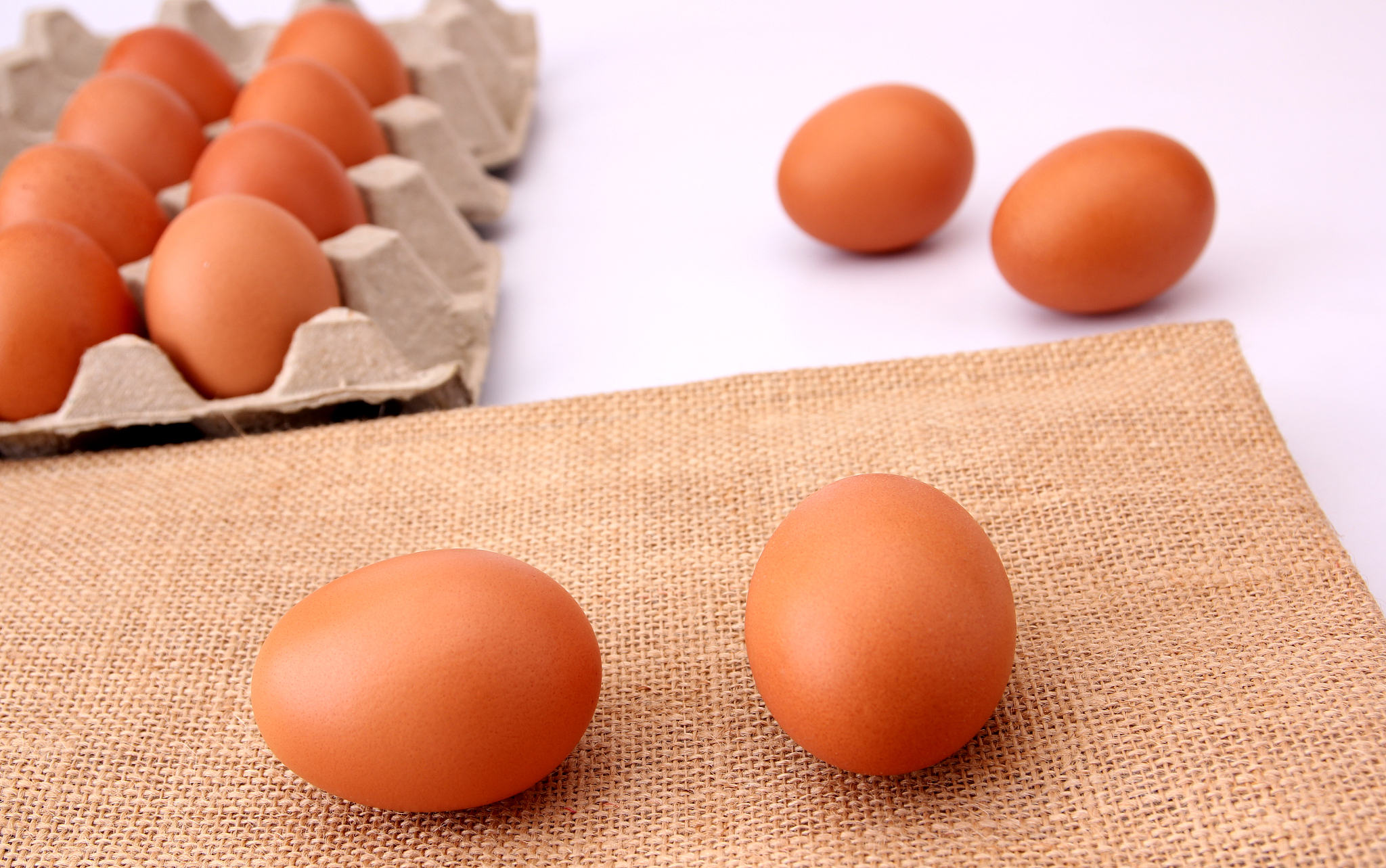 chicken eggs isolated on the sackcloth backdrop.