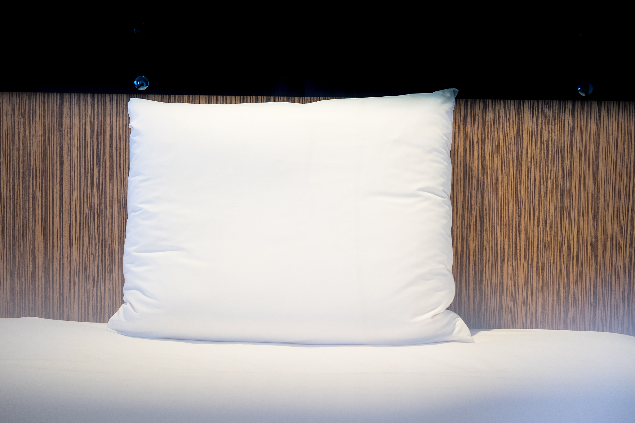 white bedding and pillow in hotel room, pillows white color