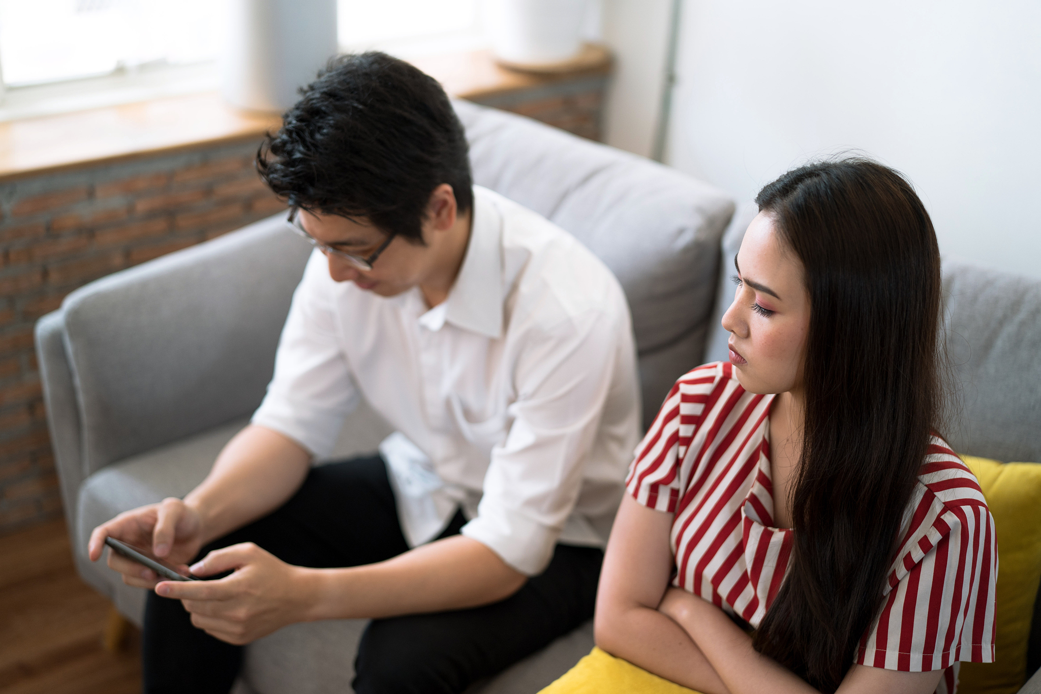 the woman looked at her boyfriend in anger because he kept playi