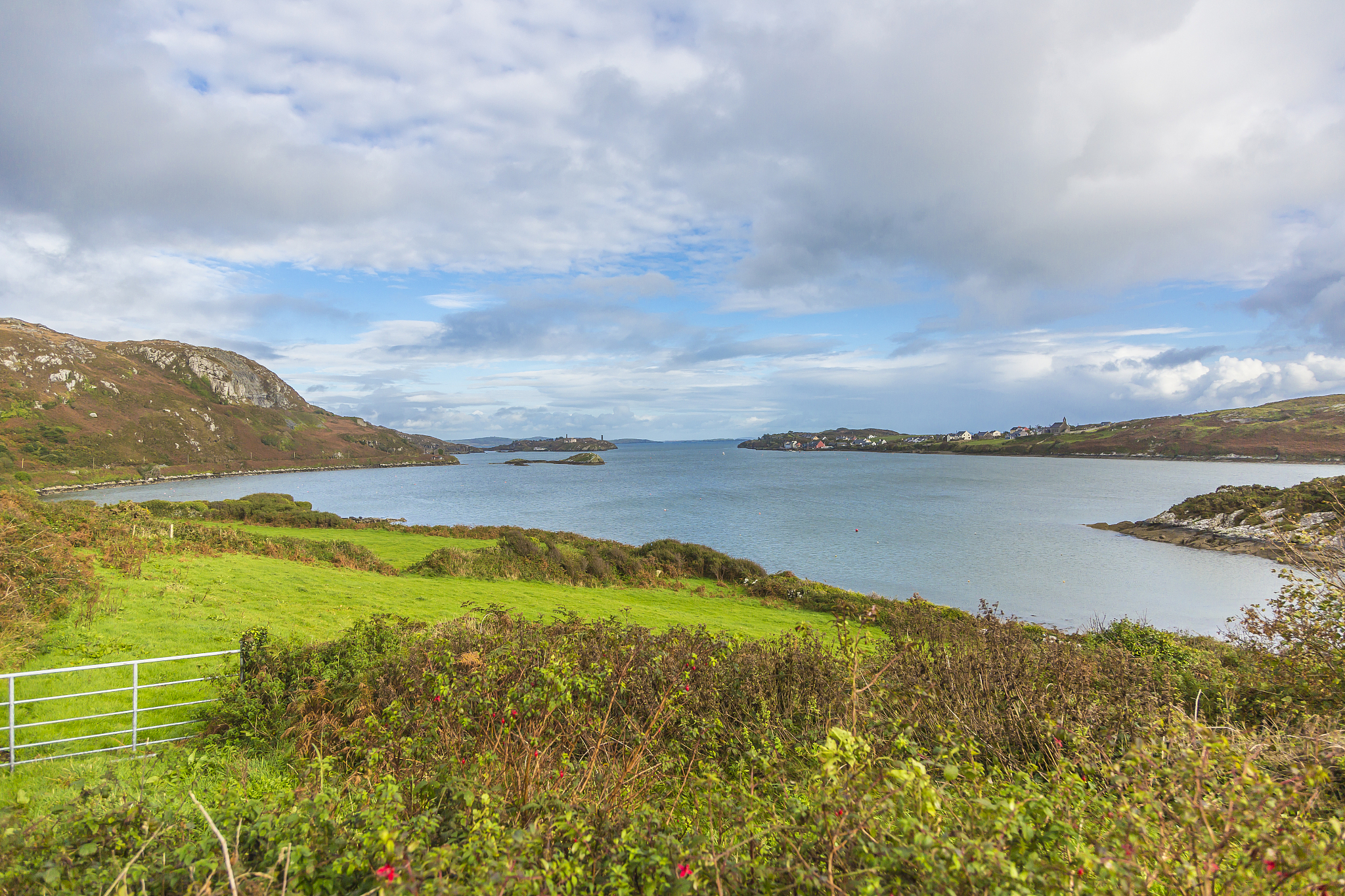 panorama picture of typical irish coast line with green meadows 