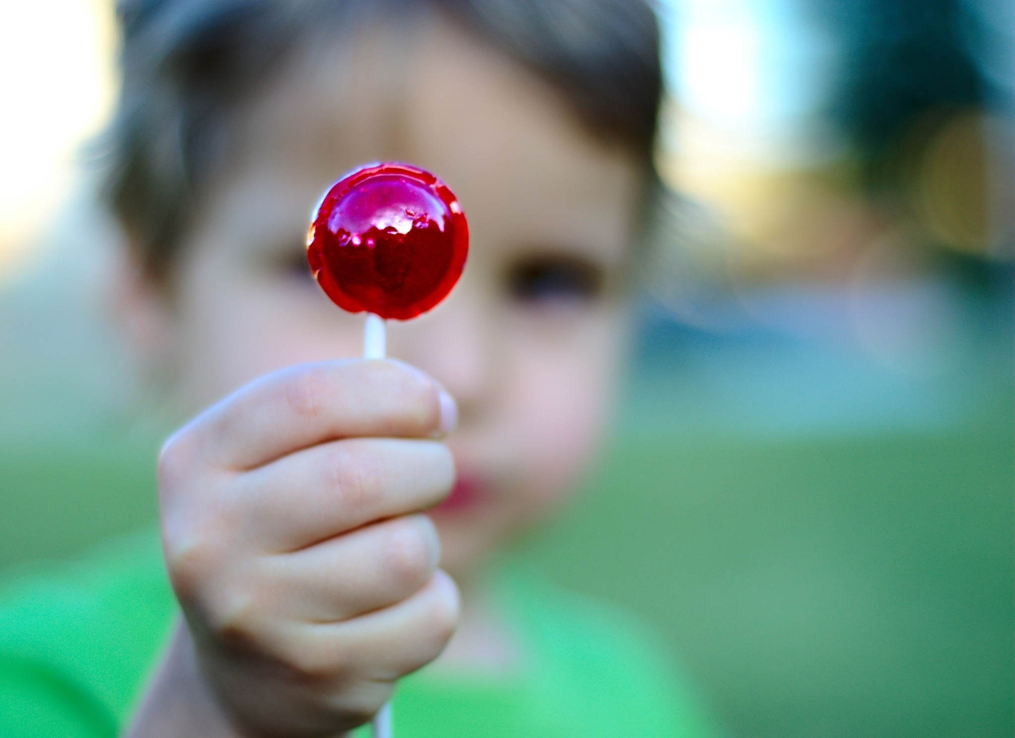 boy holding lollipop