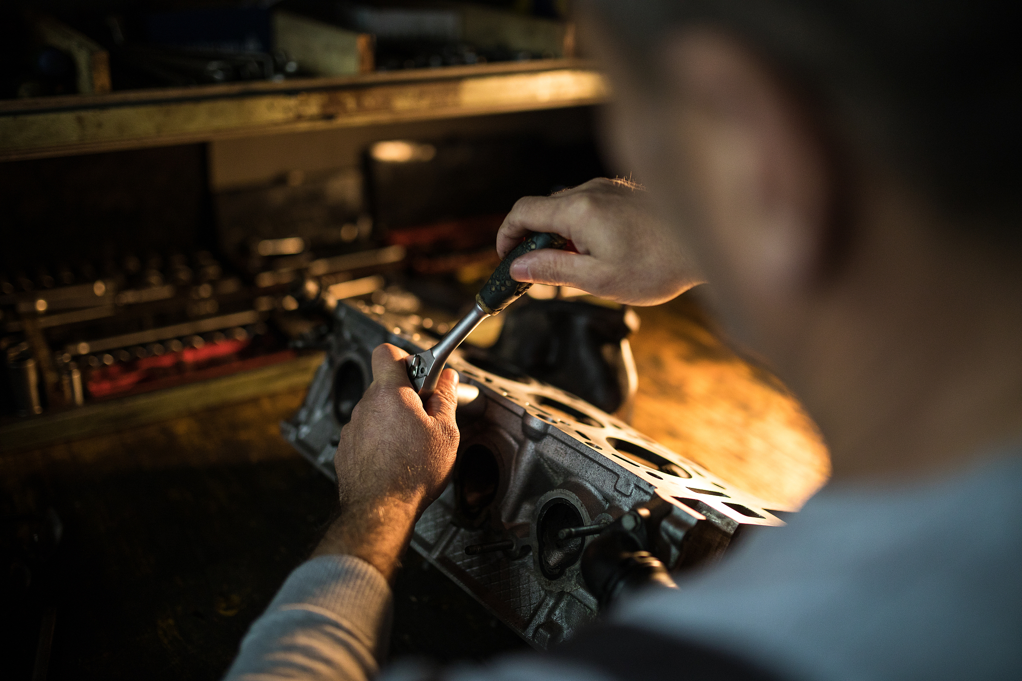 auto mechanic working on a car engine in repair shop