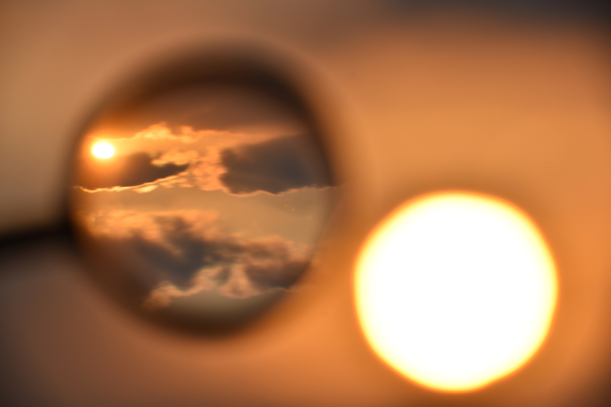 magnifying glass and sunset silhouette