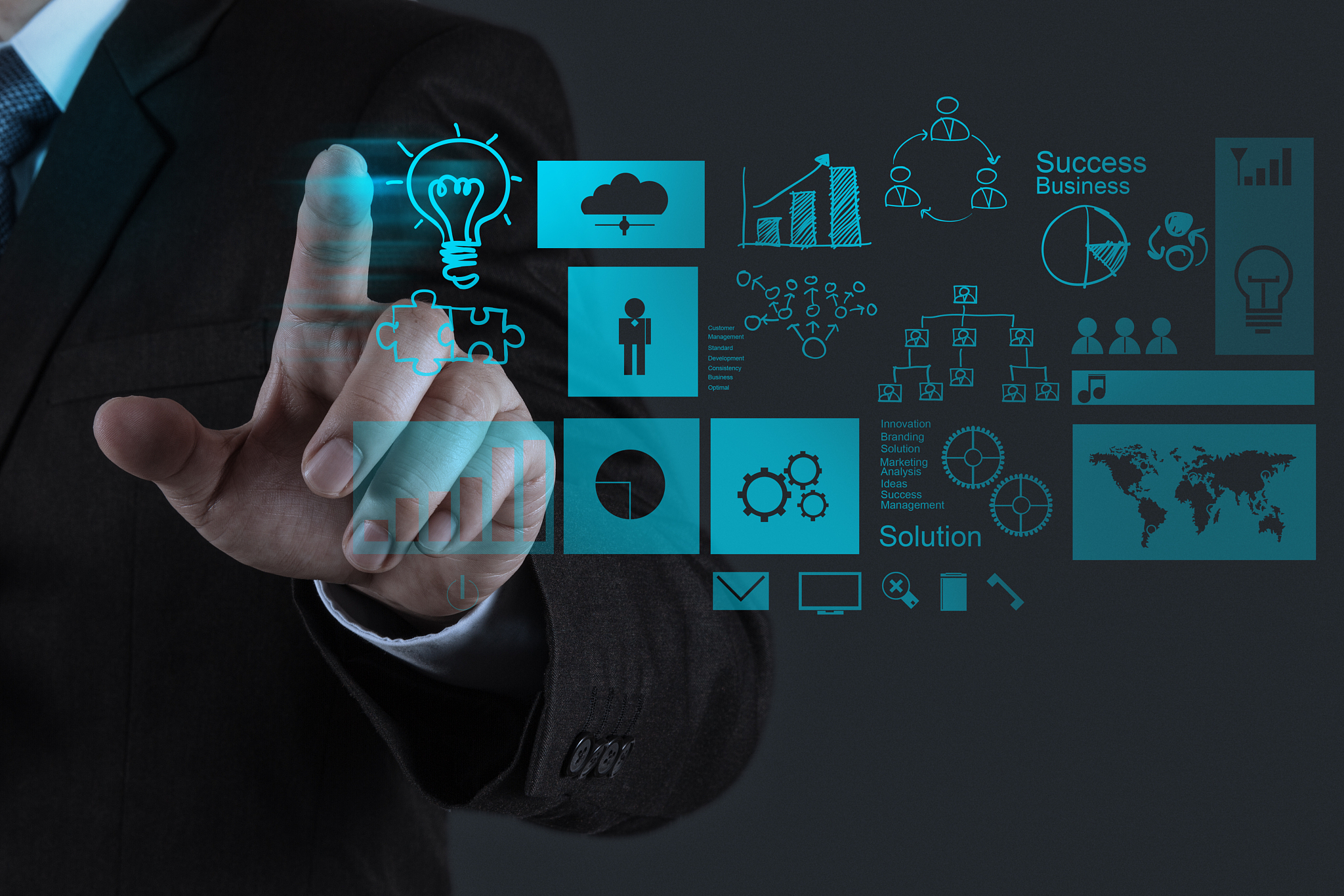 businessman touches hologram of business solutions