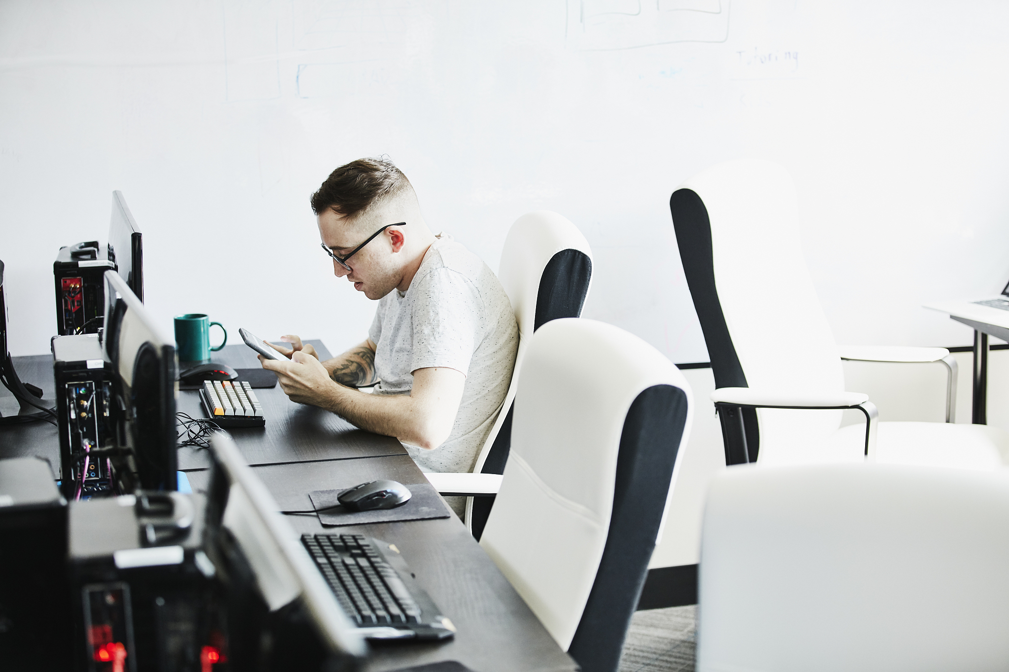 engineer looking at smart phone while working in computer lab