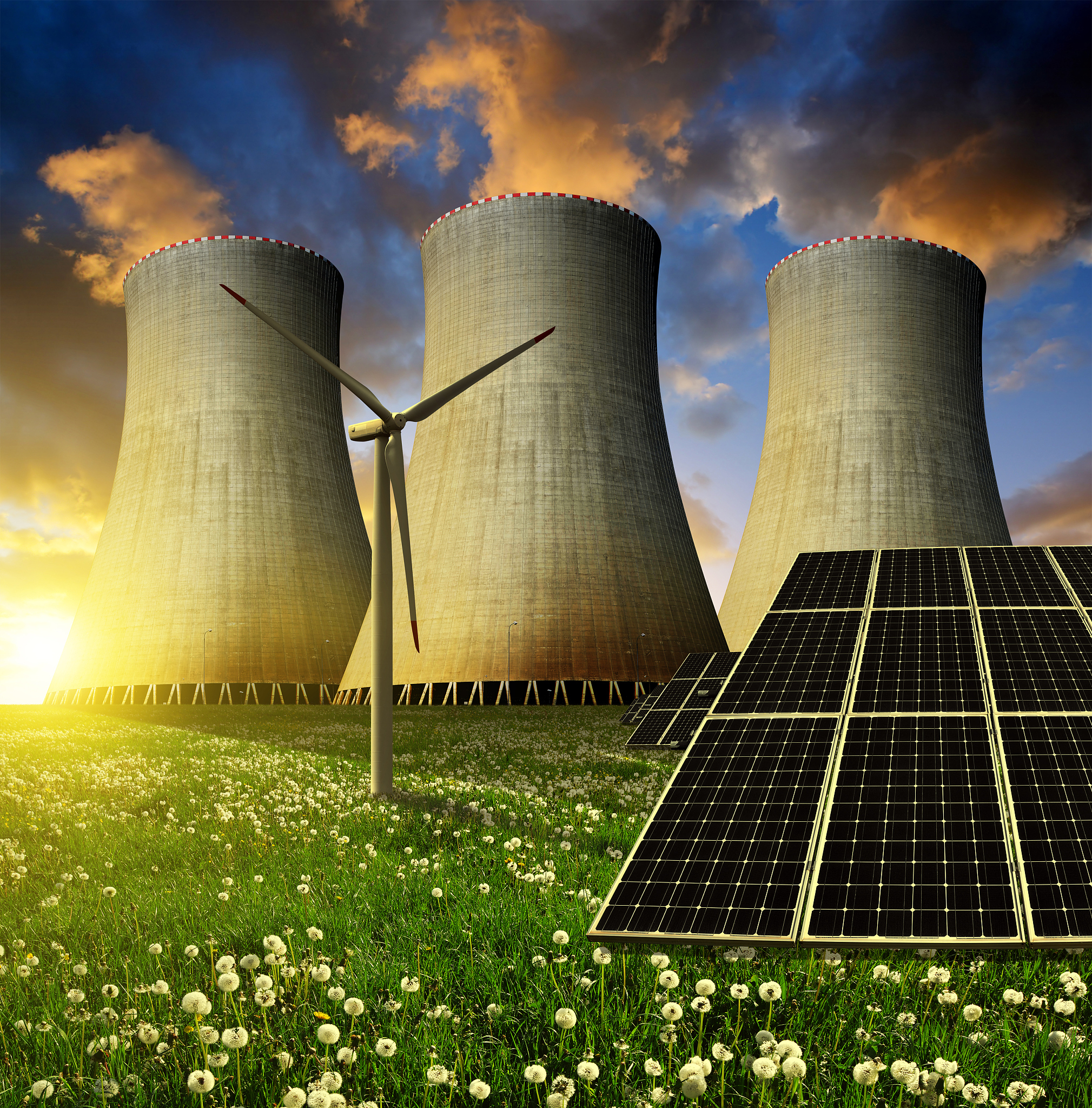 solar panels before a nuclear power plant and wind turbine