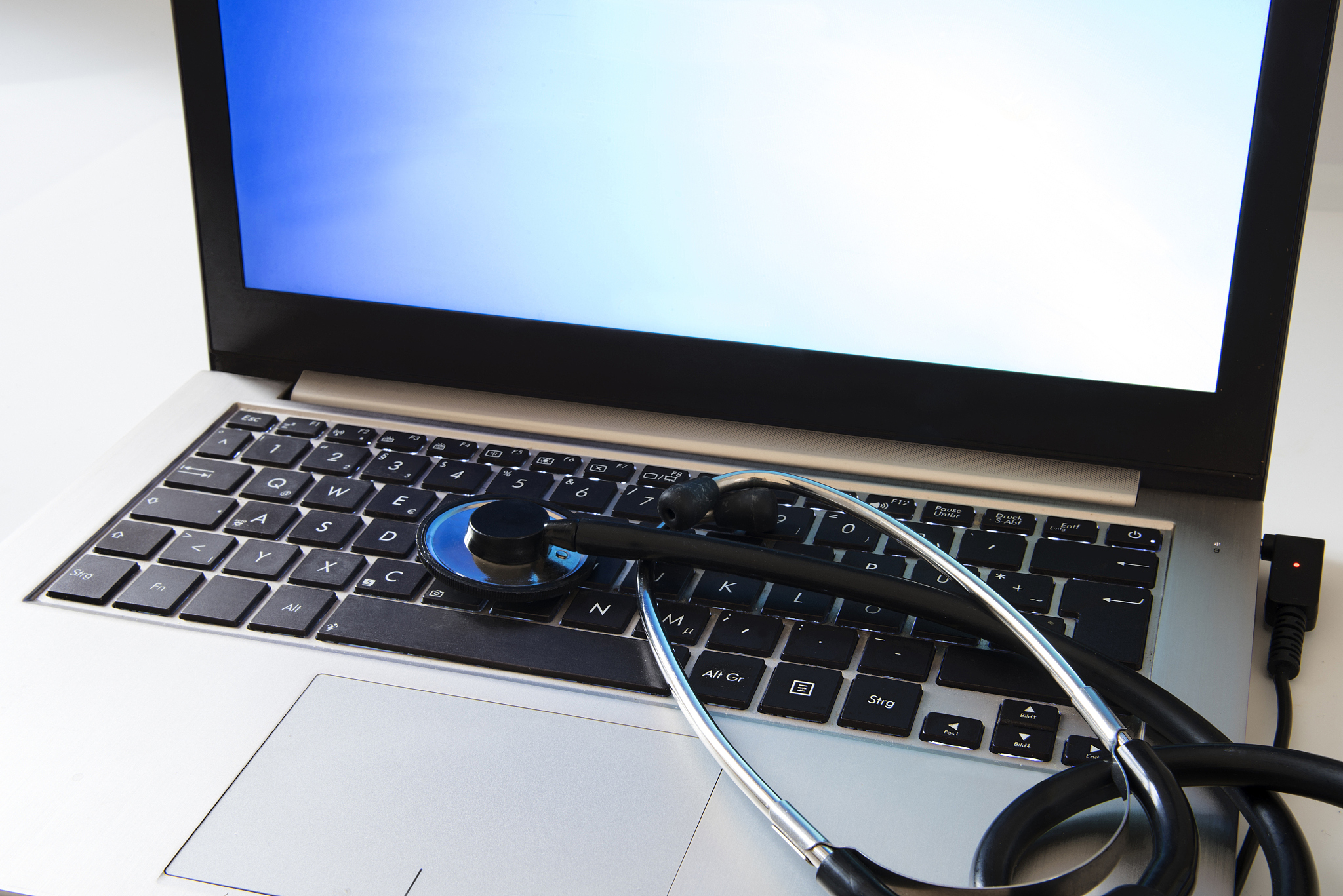 computer protection, stethoscope on a business laptop keyboard