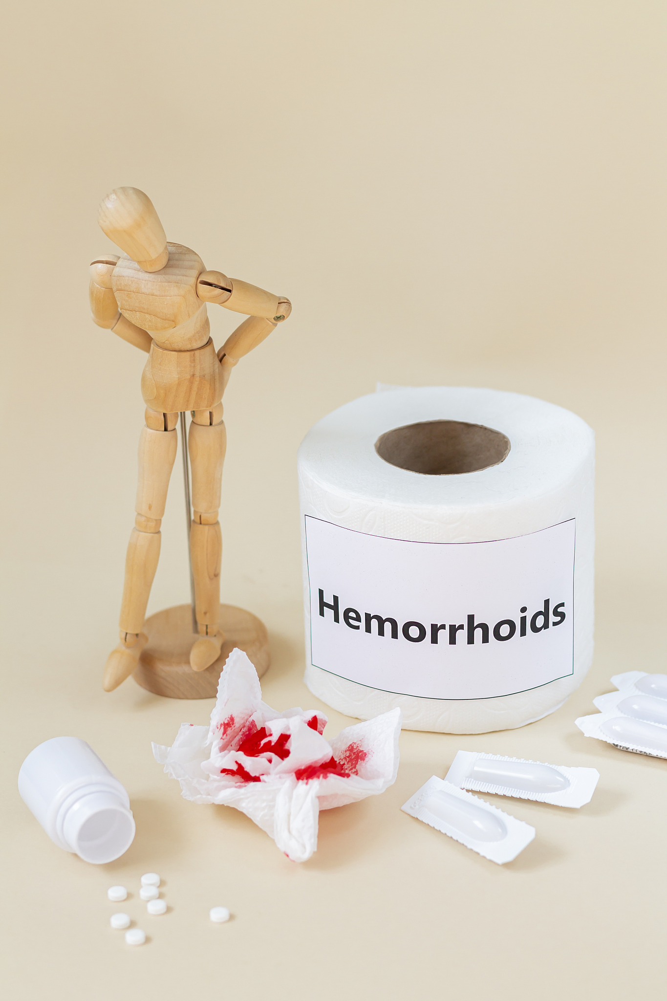 hemorrhoids concept, wooden man feel pain because of anus proble