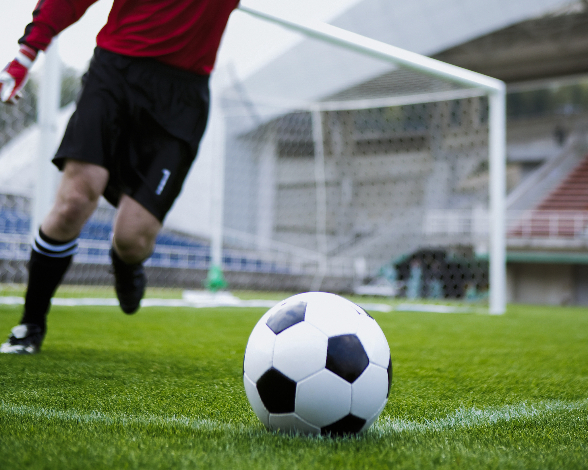player kicking football