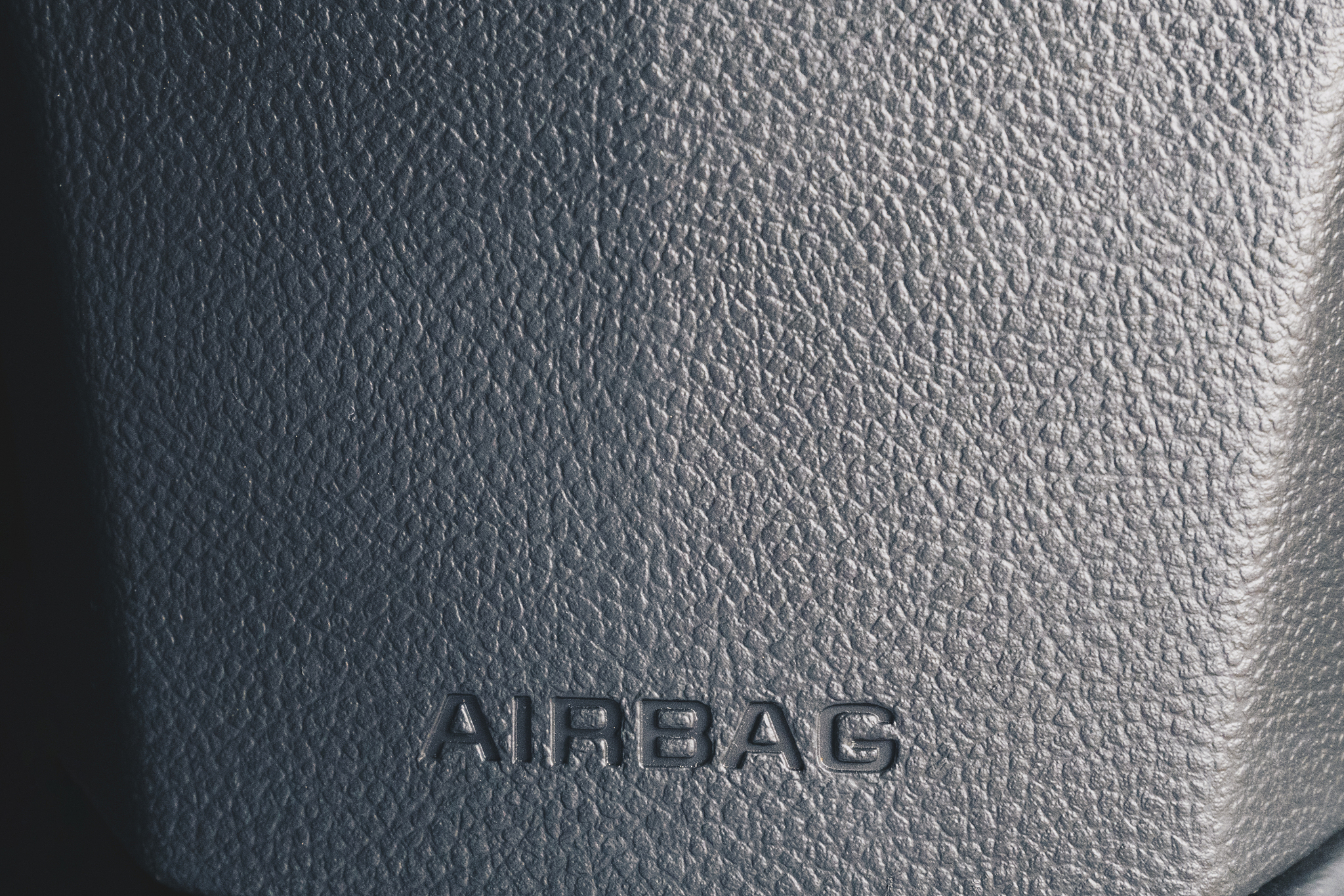 clos up airbag sign on a cars dashboard