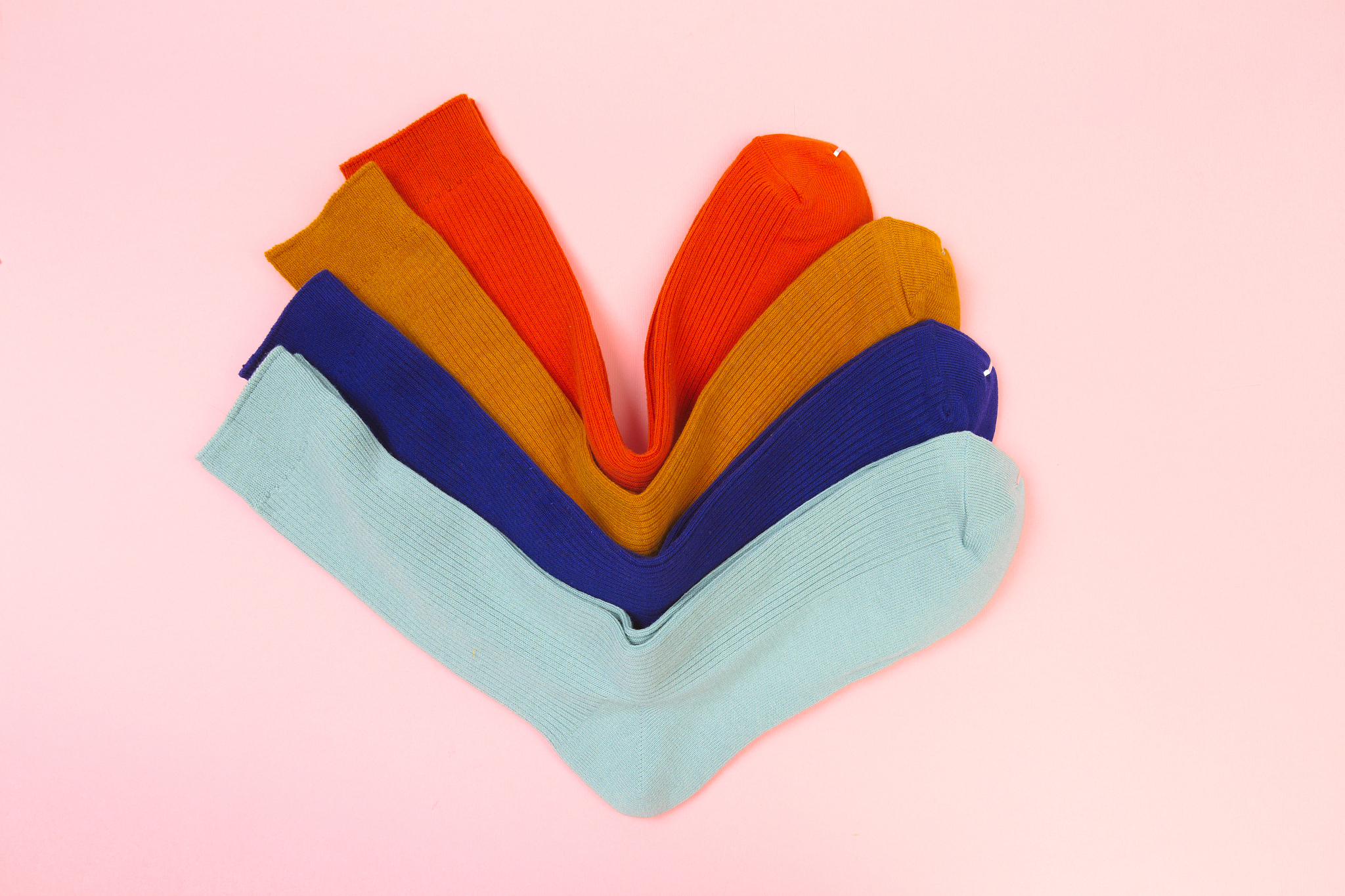 colorful socks on pink background