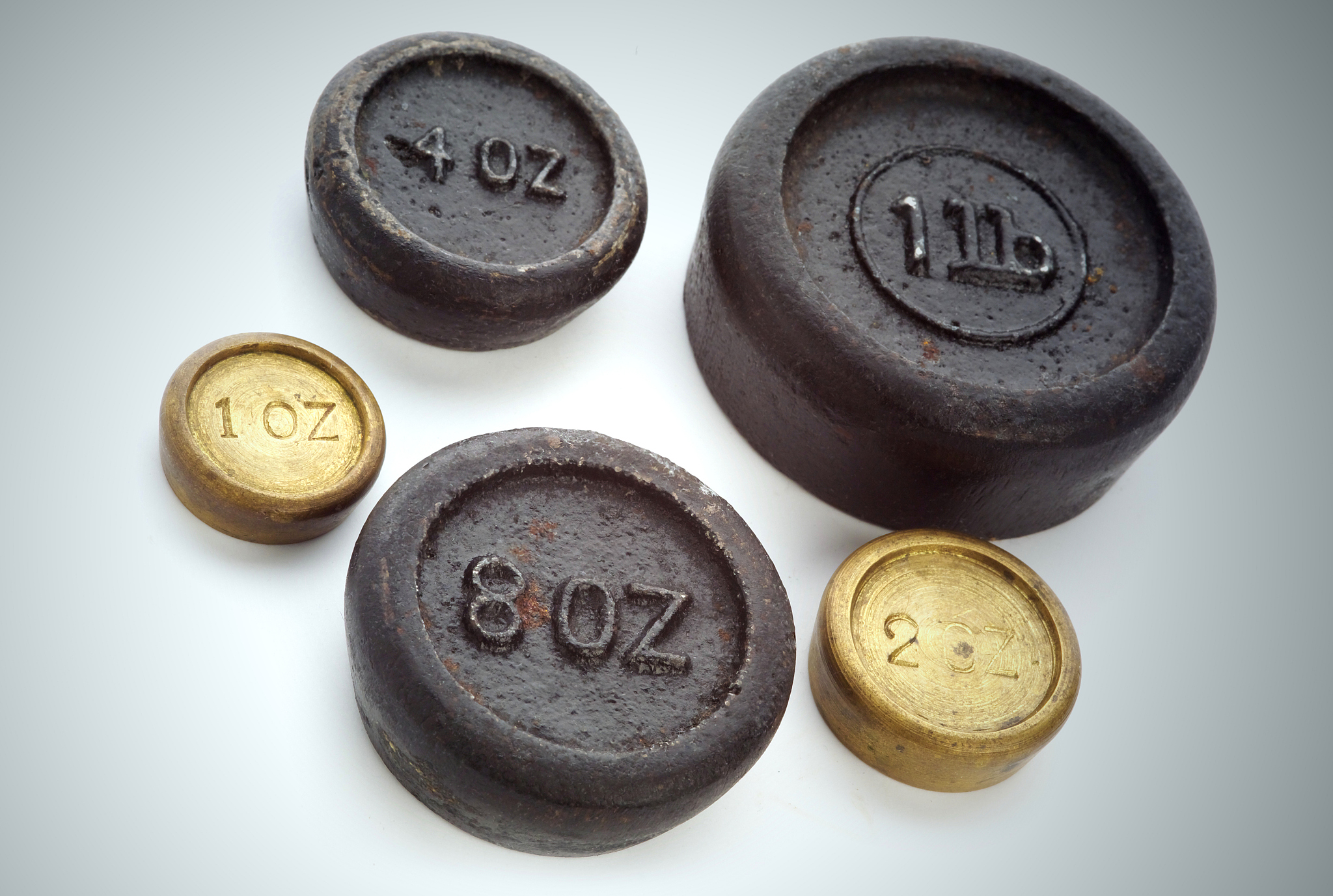 grungy old imperial weights, spotlit