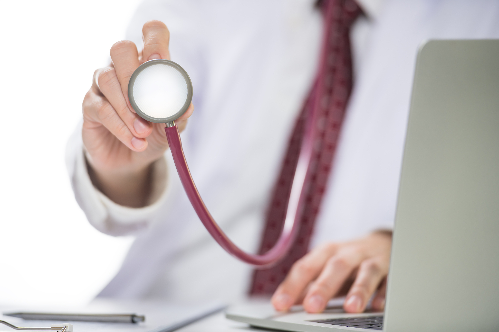 medical doctor holding stethoscope in hospital setting