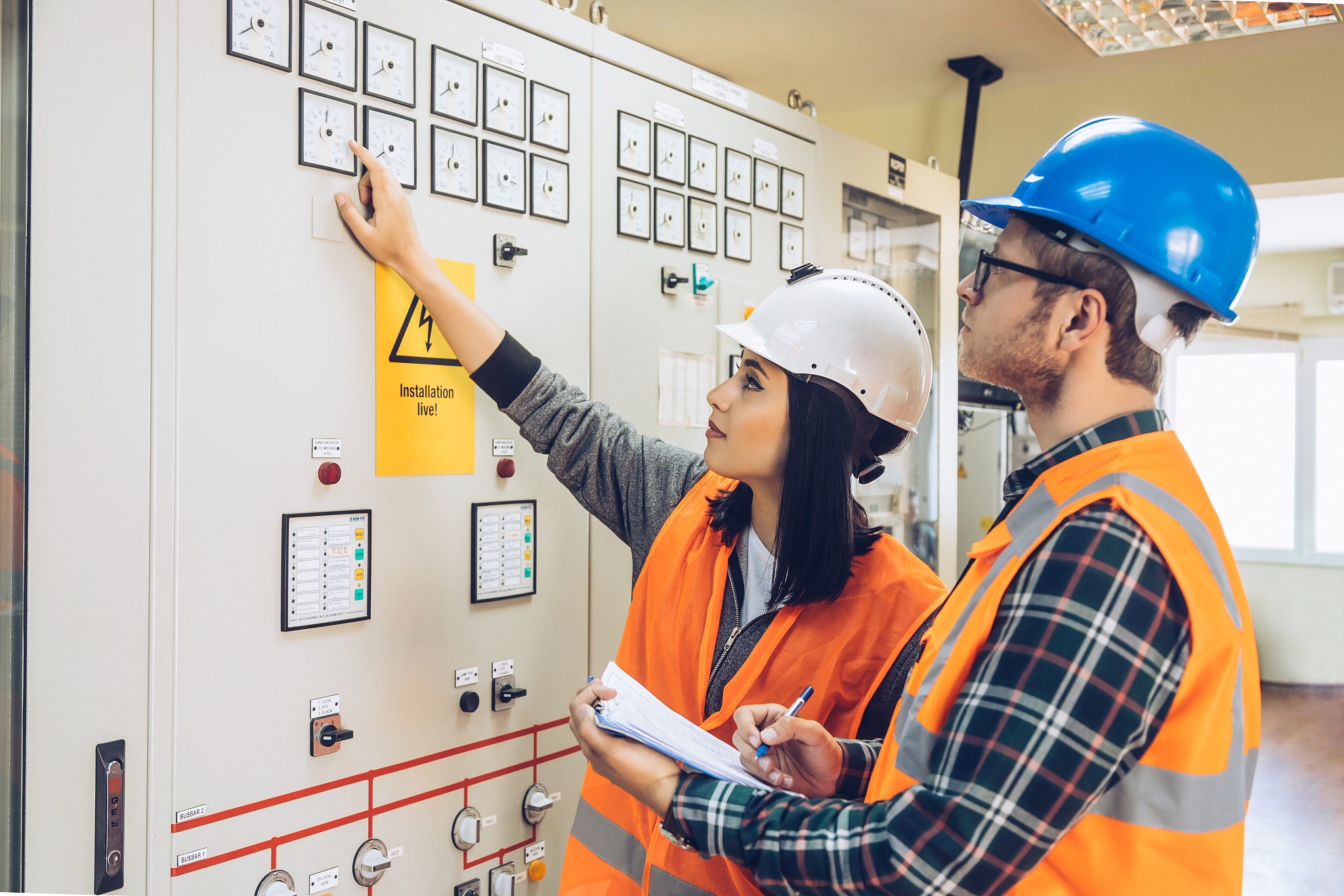 young maintenance engineer team working at energy control room