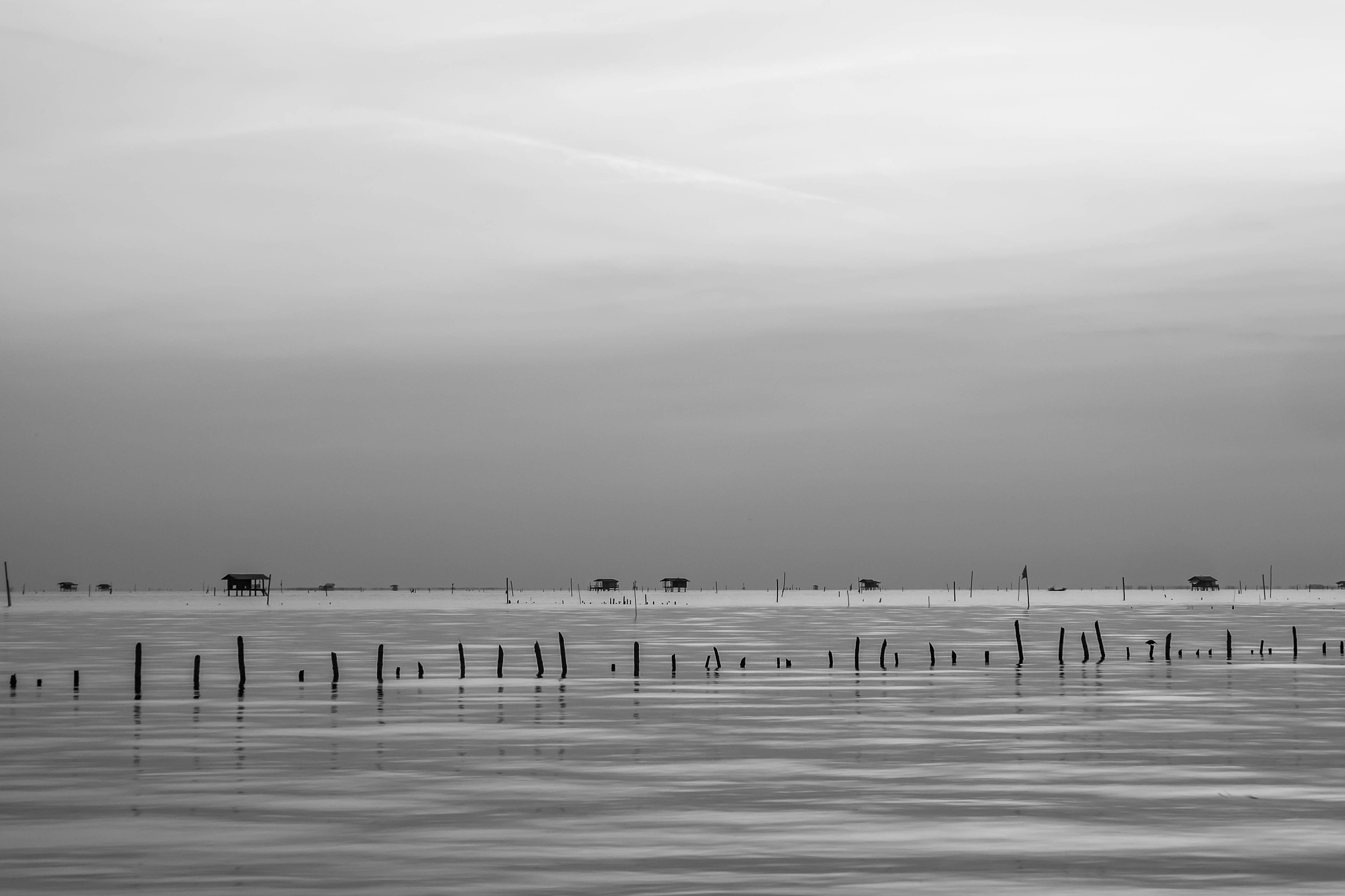 black and white picture of old bridge to the sea as background