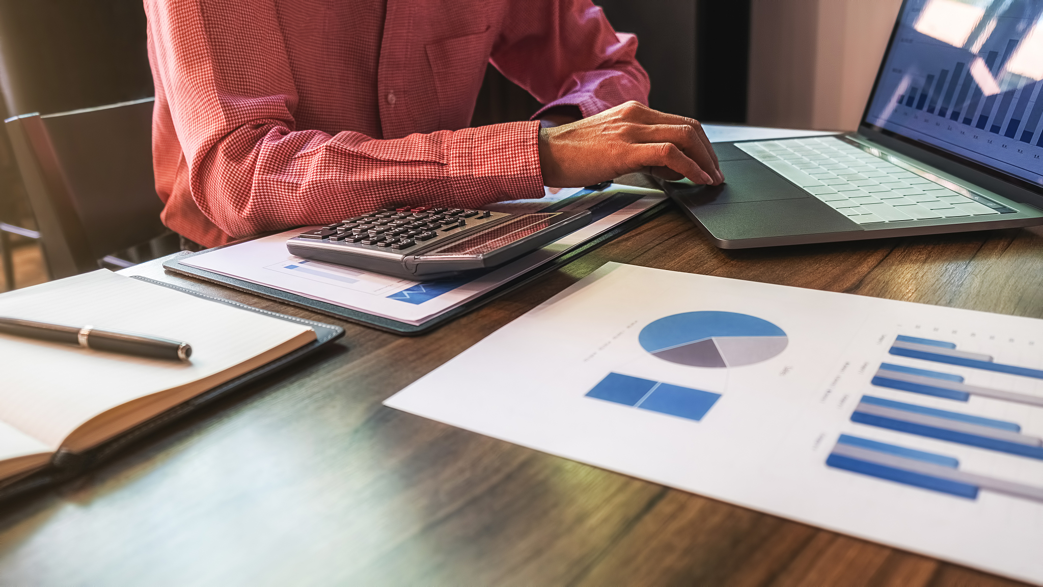businessman using laptop to checking the company performance cha