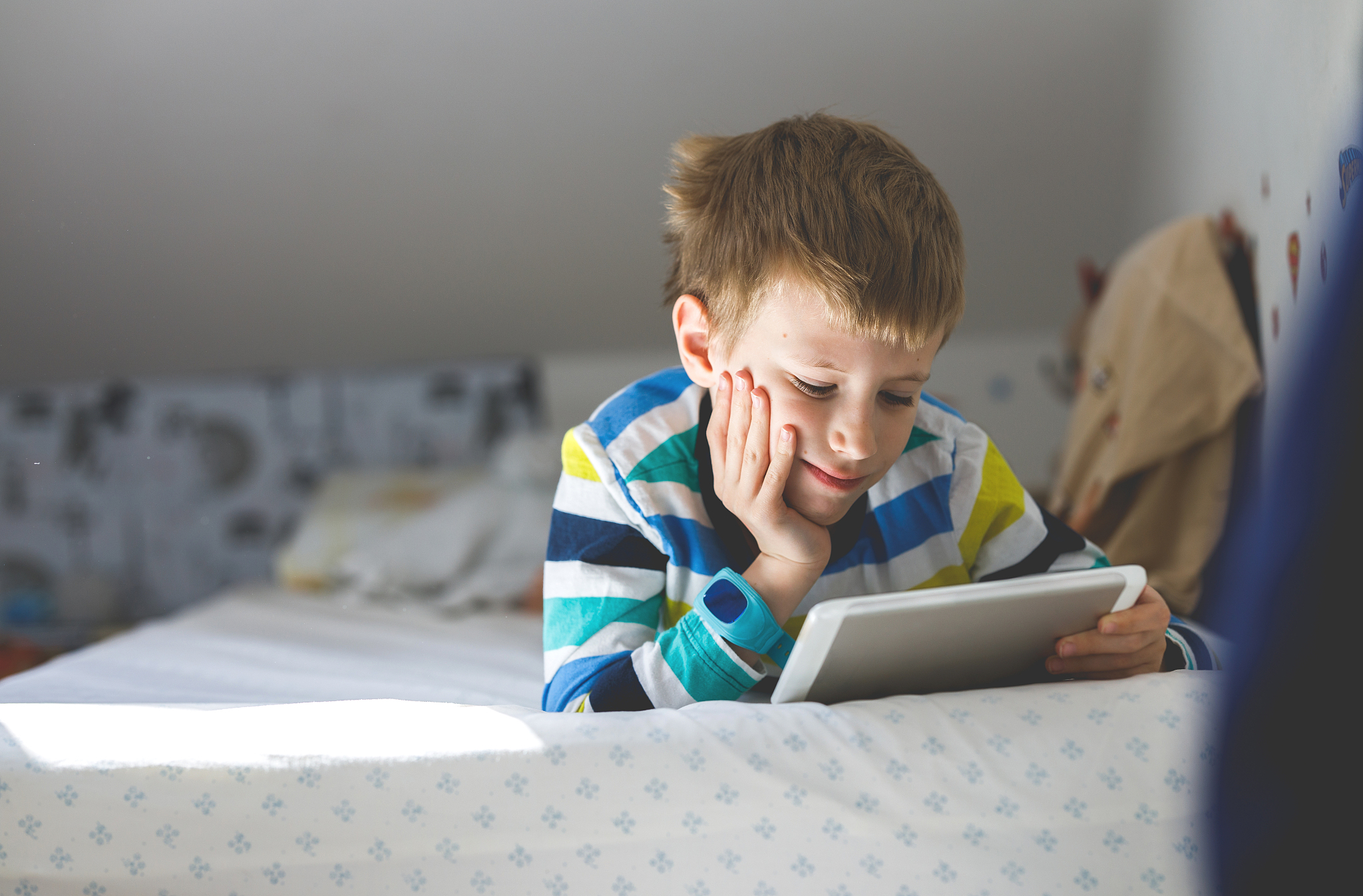 young boy looking at digital tablet