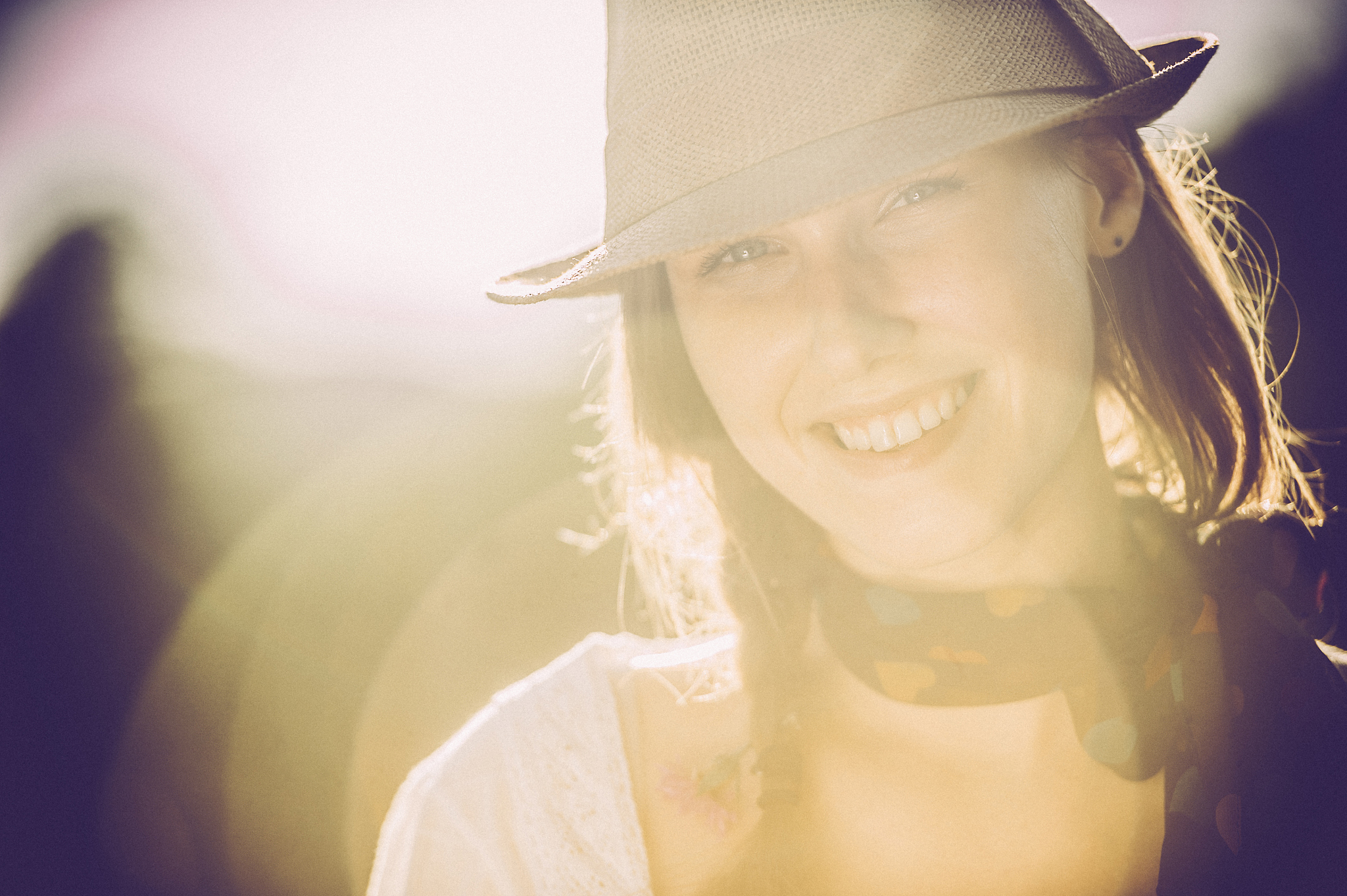 beautiful young woman portrait smiling, against sun