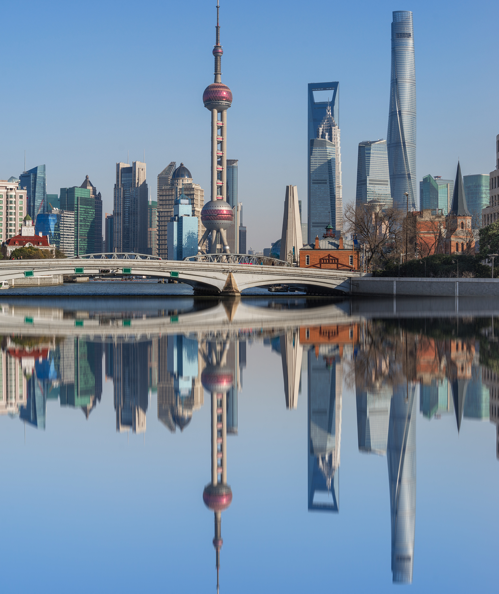 river and modern buildings against sky in shanghai