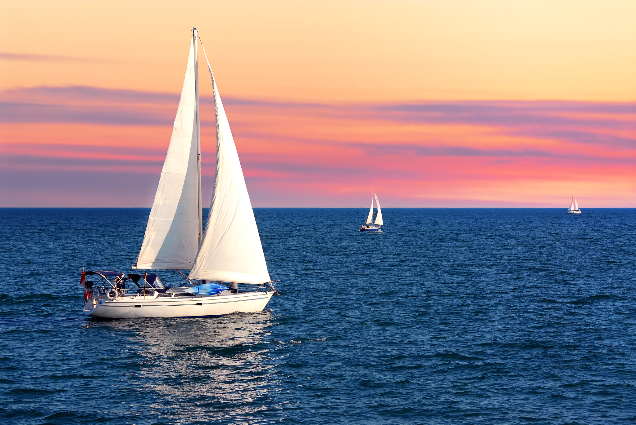sailboats at sunset