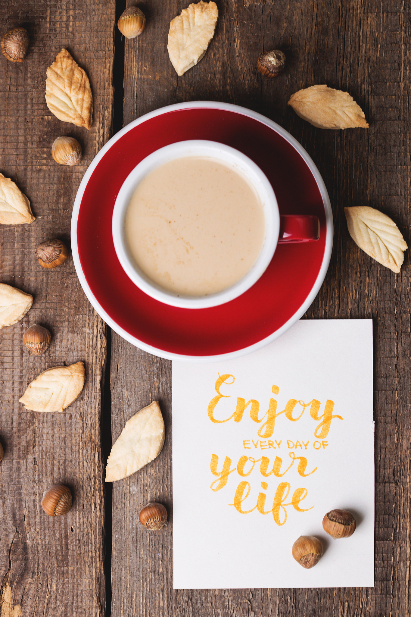 red cup of coffee and leaf shape cookies"n