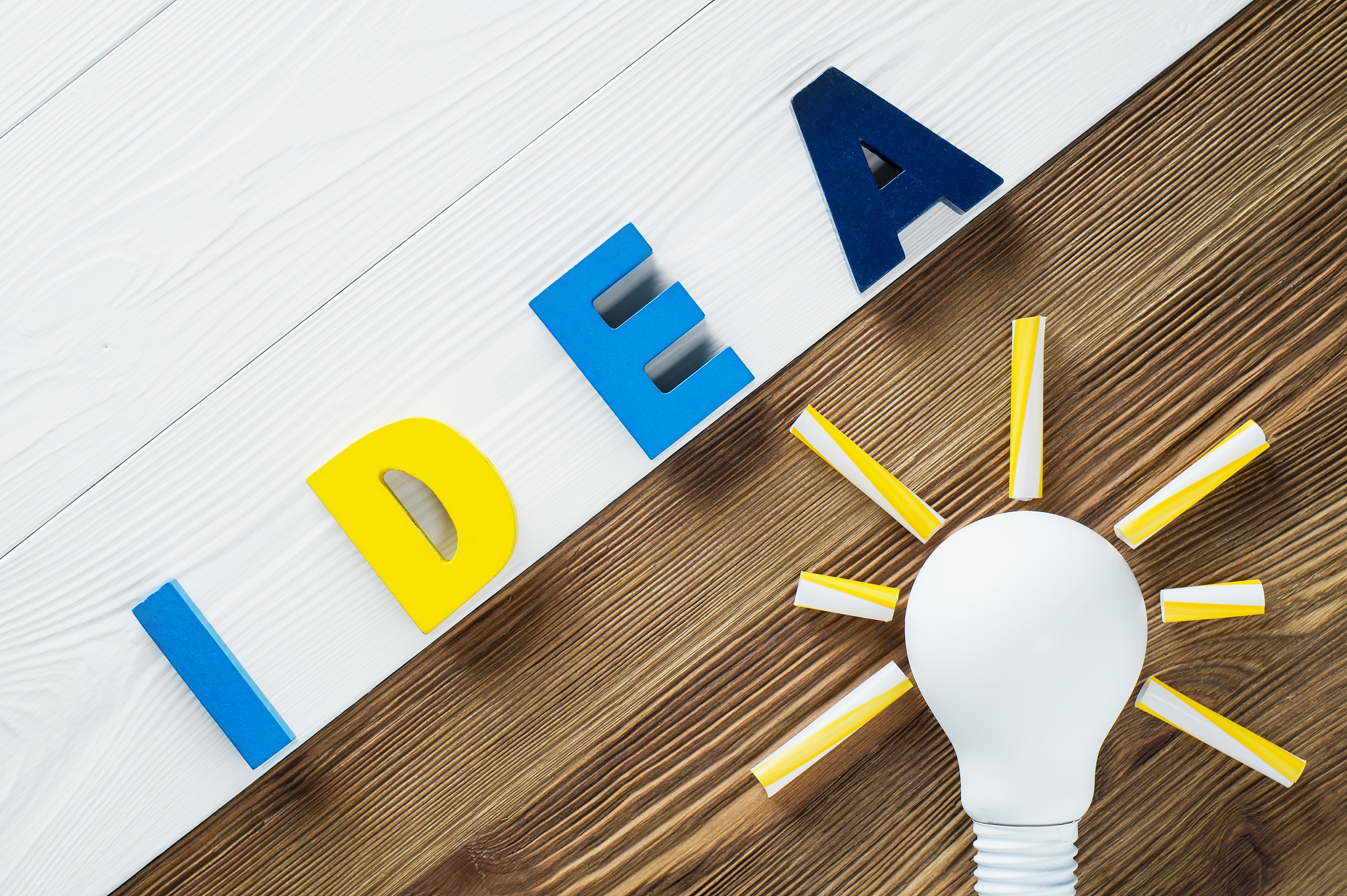 lightbulb and idea word on the wooden background.