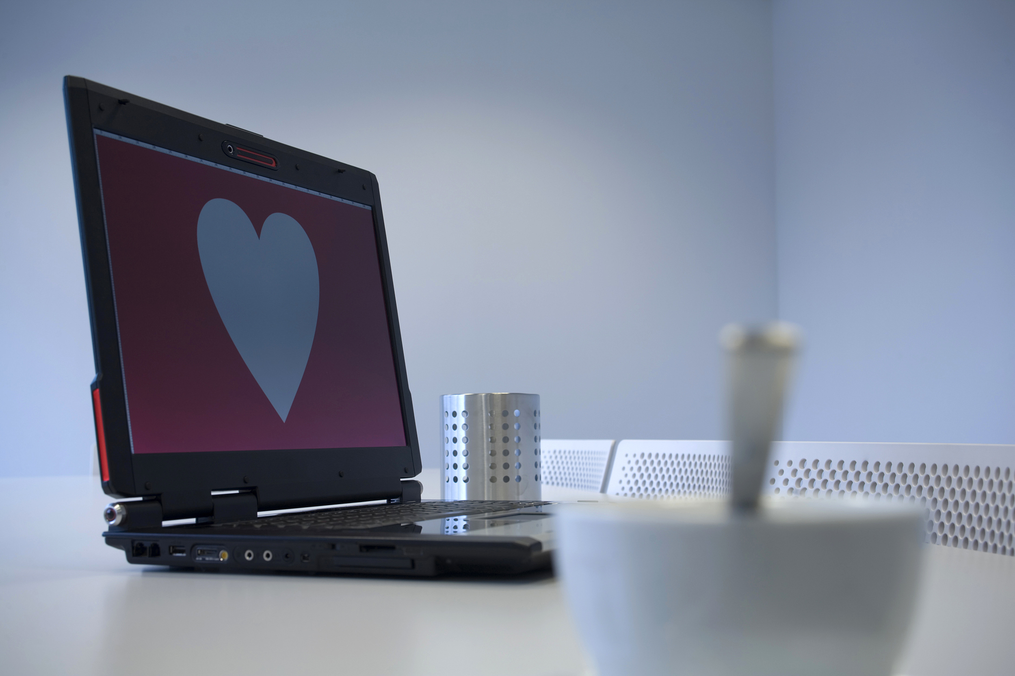 white cup and heart shape on a computer monitor