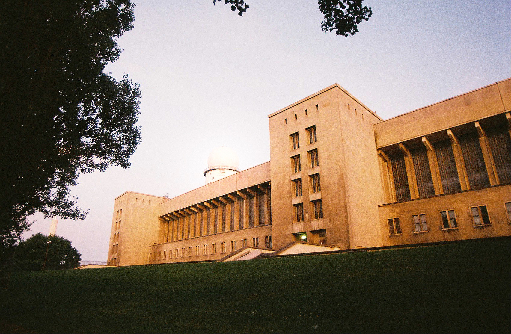 building against clear sky with lawn in foreground