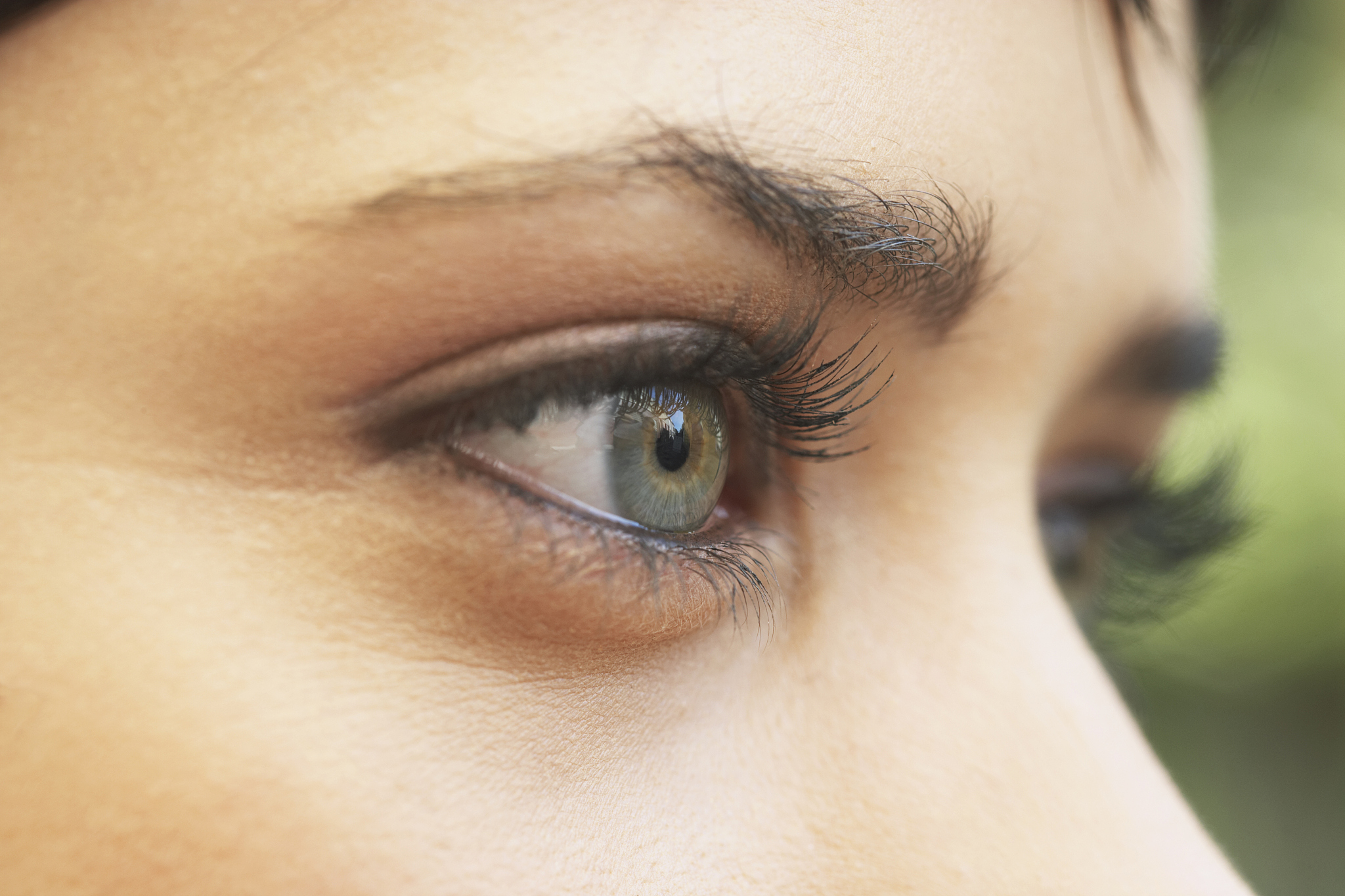 young woman wearing eye make-up, high section, close-up
