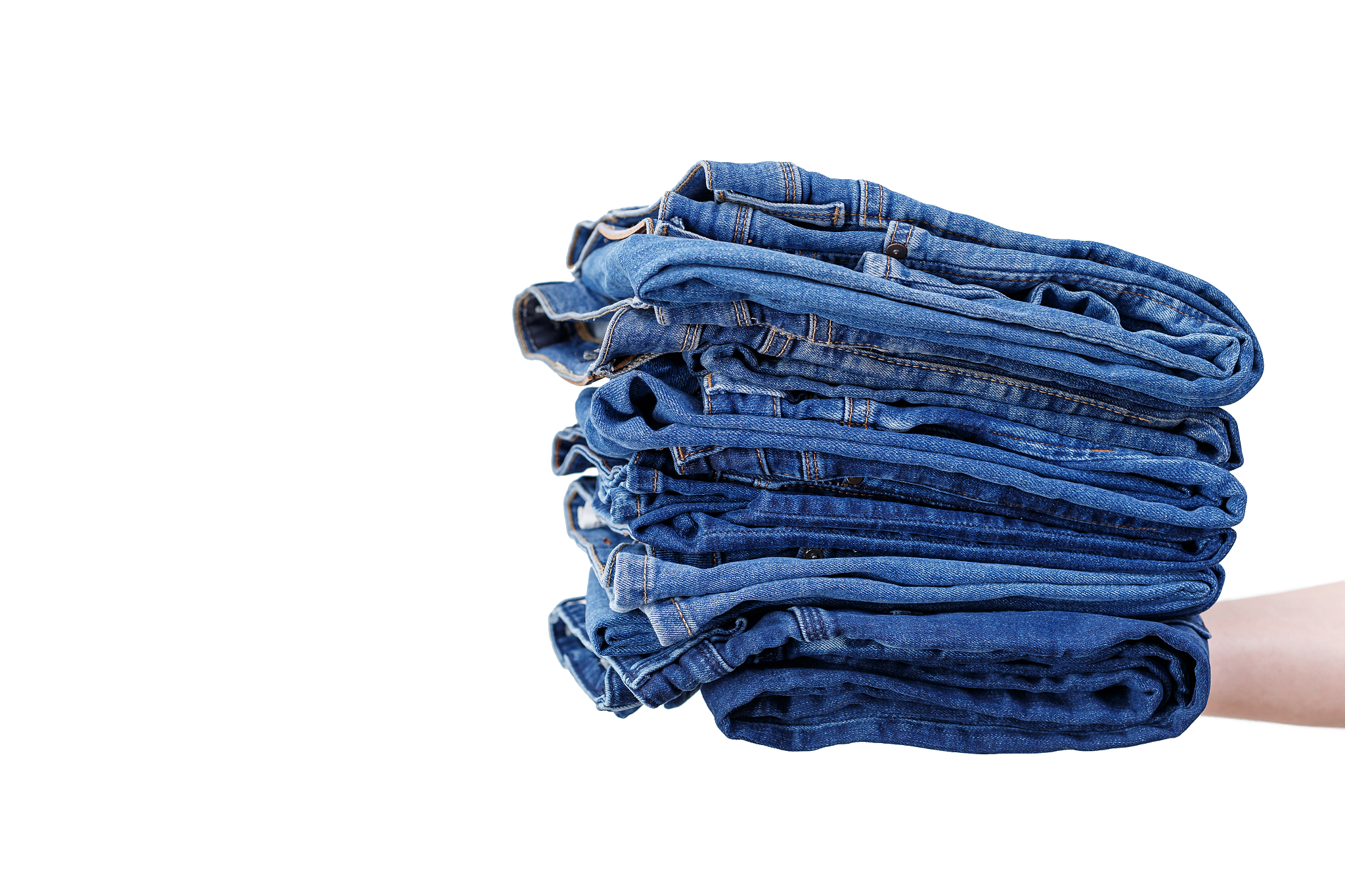 jeans on a white background. stack of blue jeans.detail of nice 