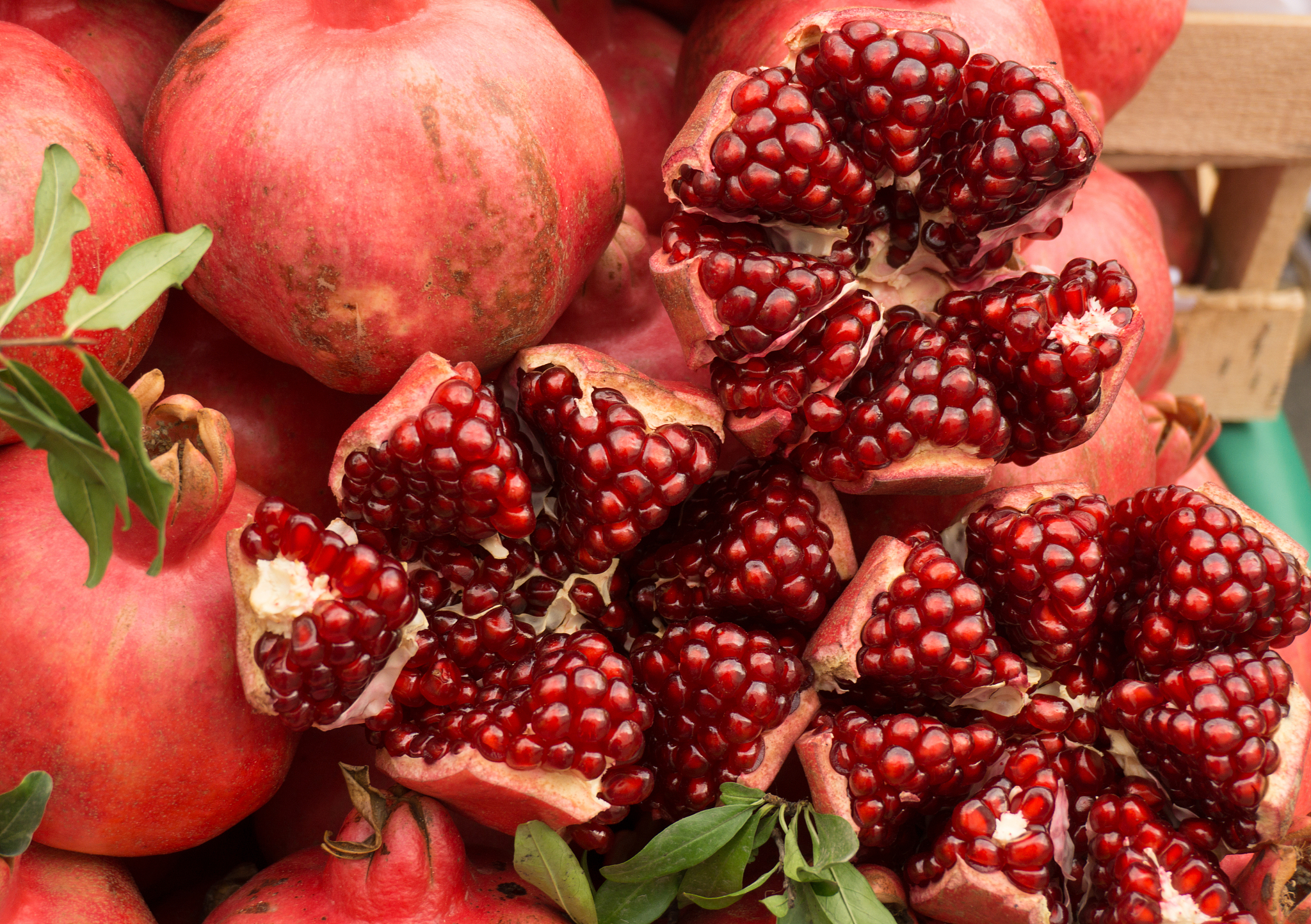 ripe red pomegranates on the market counter