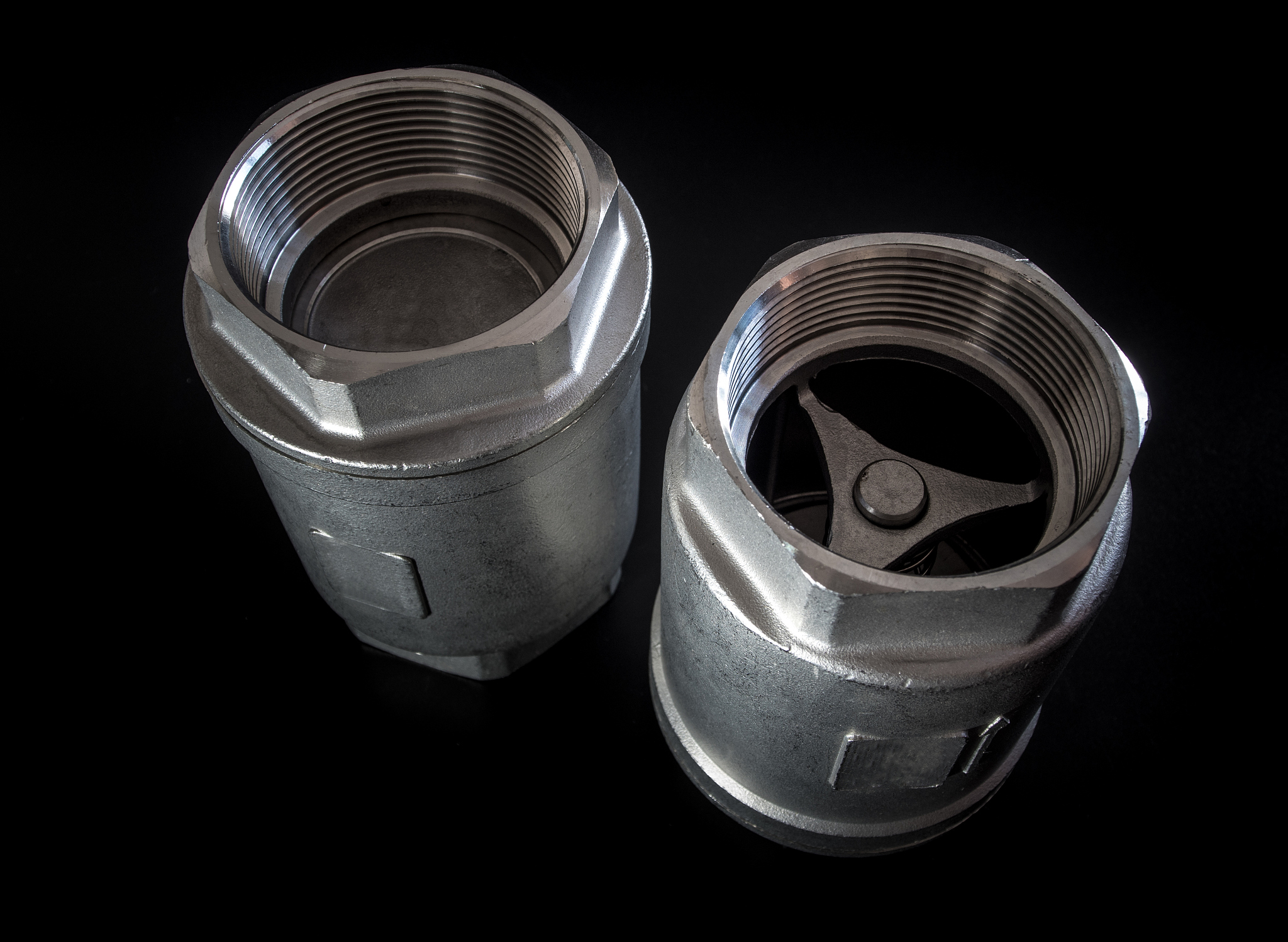 stainless steel check valve on black background