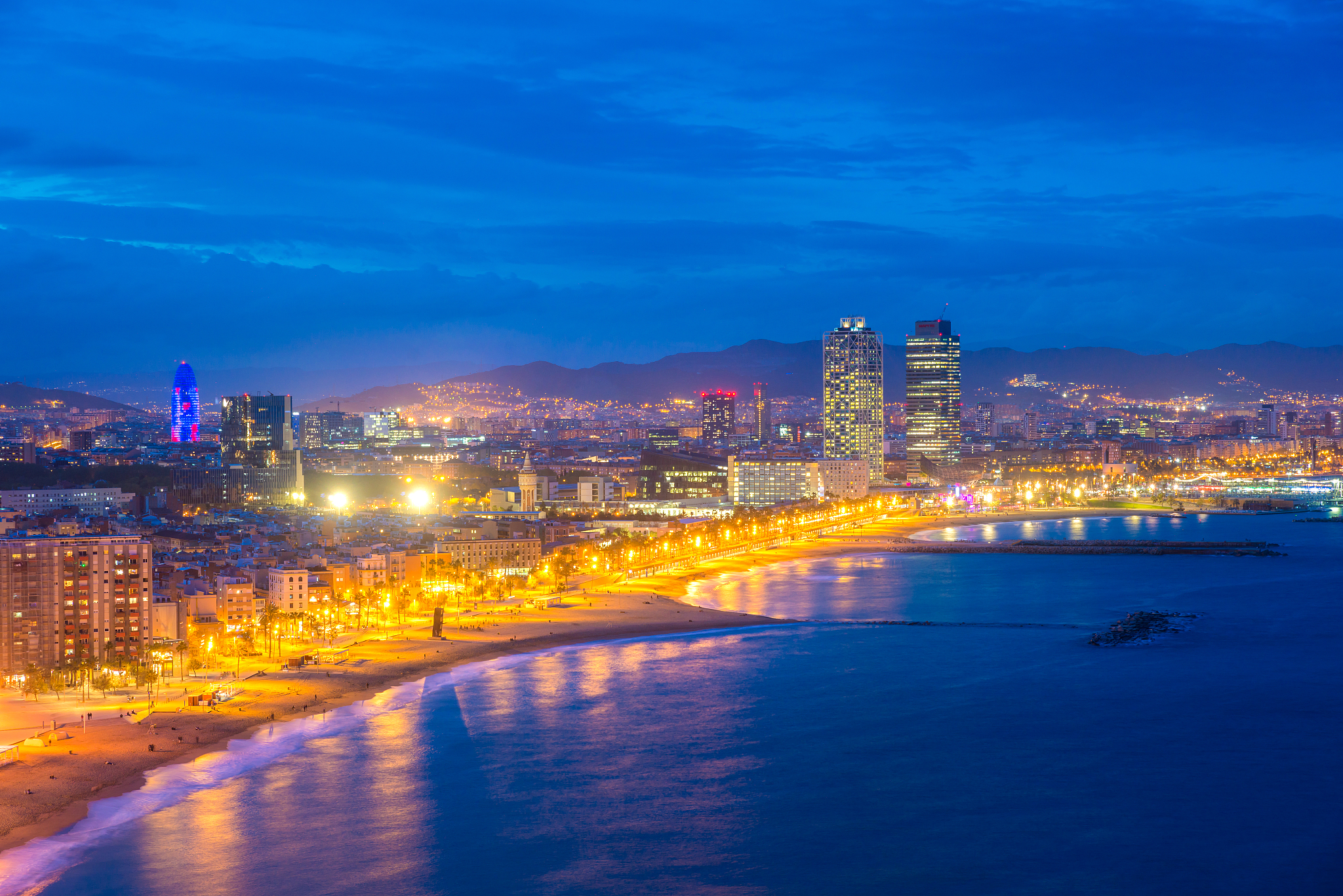 aerial view of barcelona beach in summer night along seaside in 