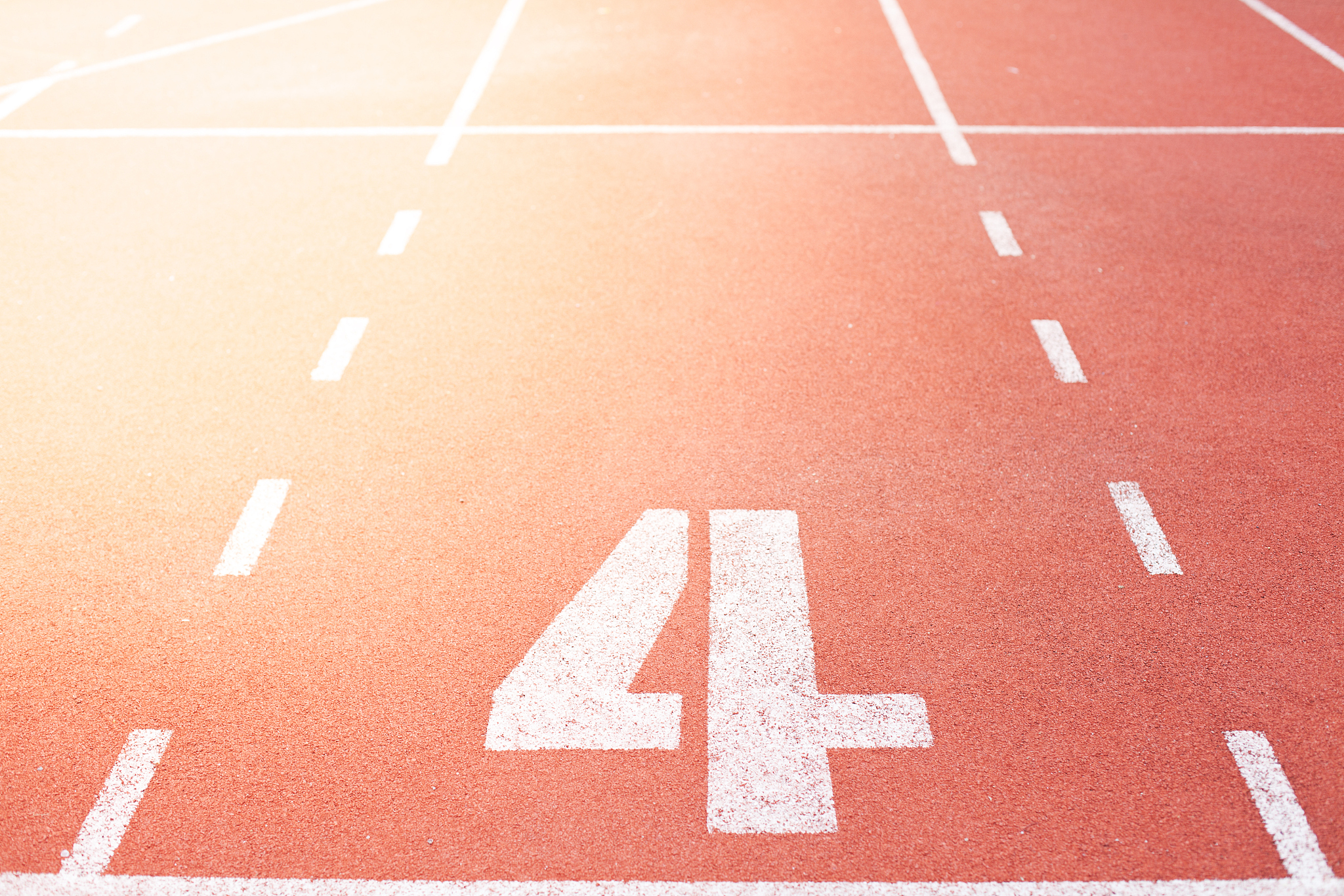 red treadmill at the stadium with the numbering number four