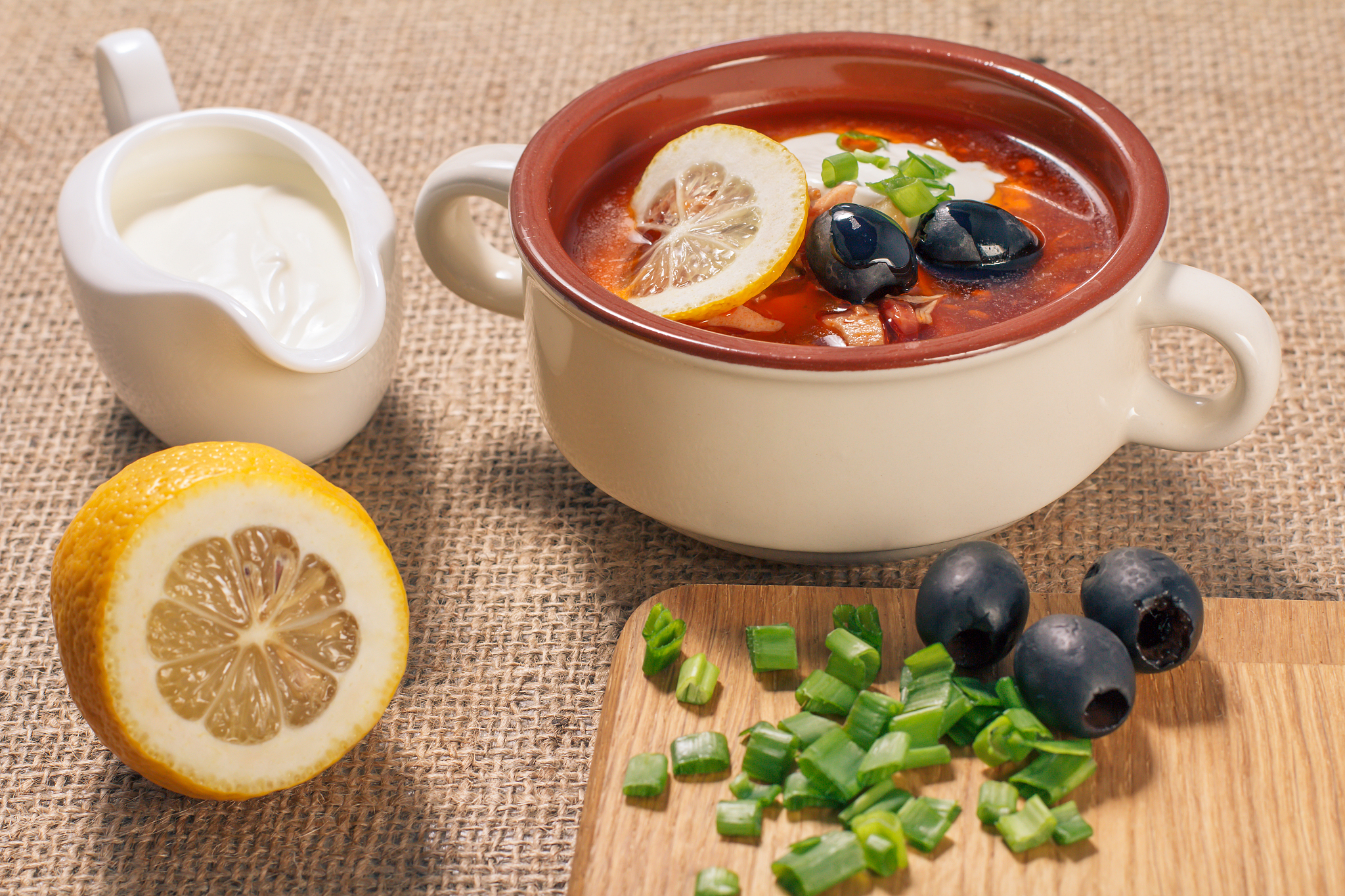 soup saltwort with meat, potatoes, tomatoes, lemon and black oli