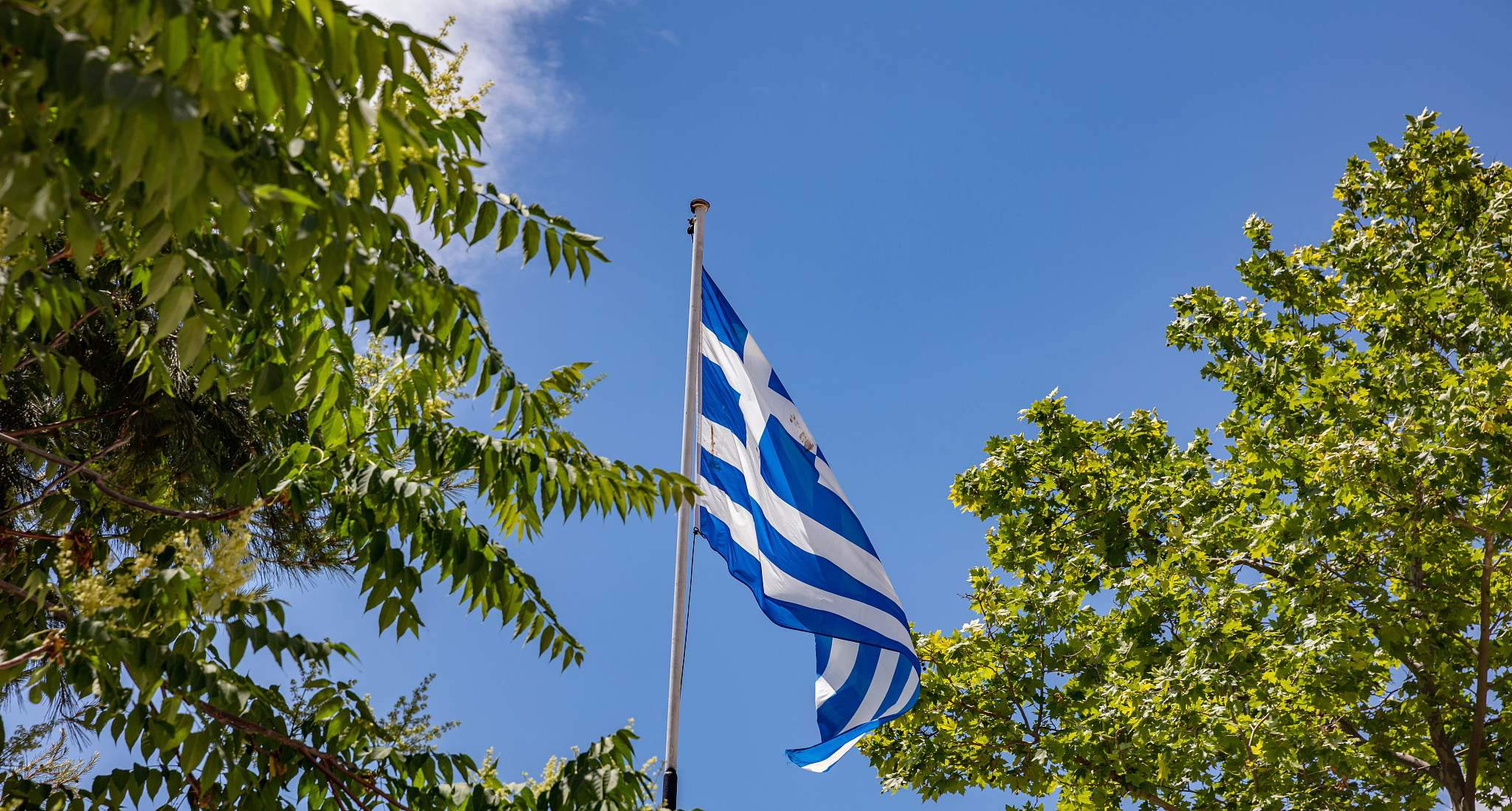 greek flag waving against blue sky background