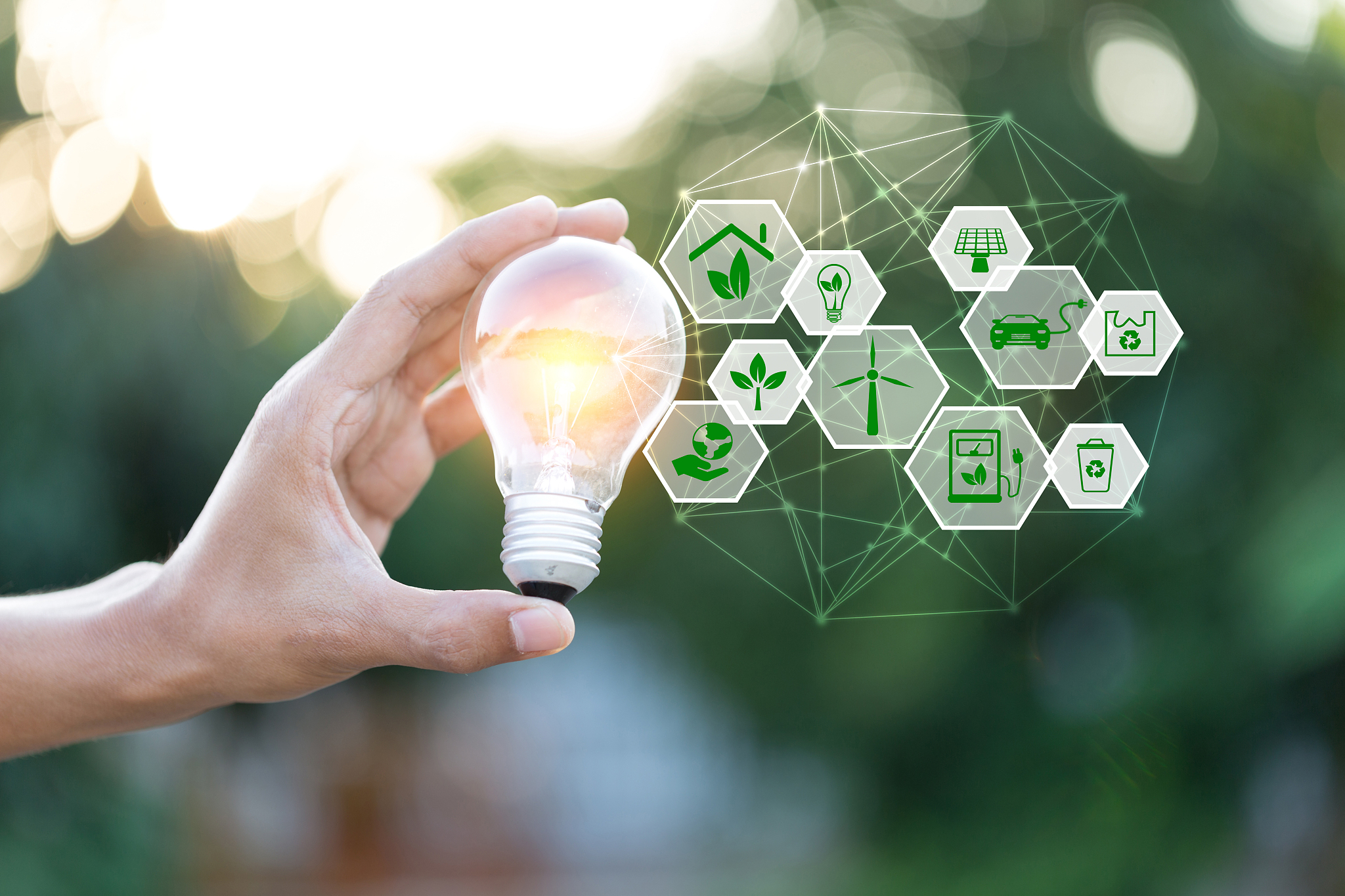 hand holding light bulb with icons energy sources for renewable,