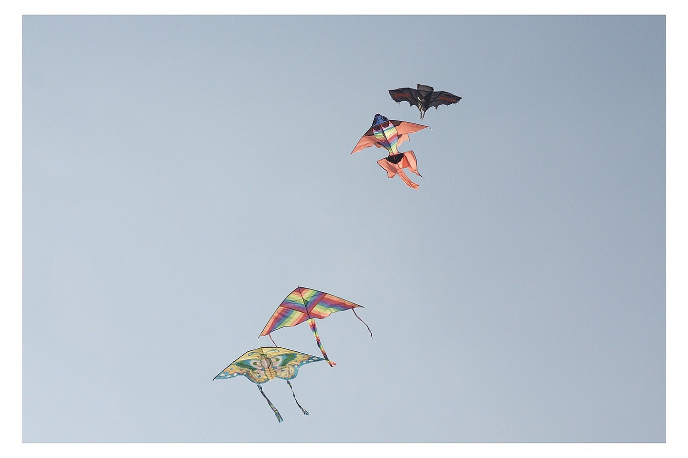 low angle view of kites flying against clear sky