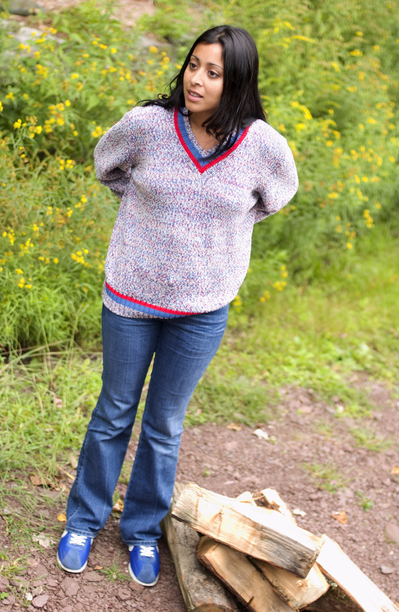 woman standing by firewood pile