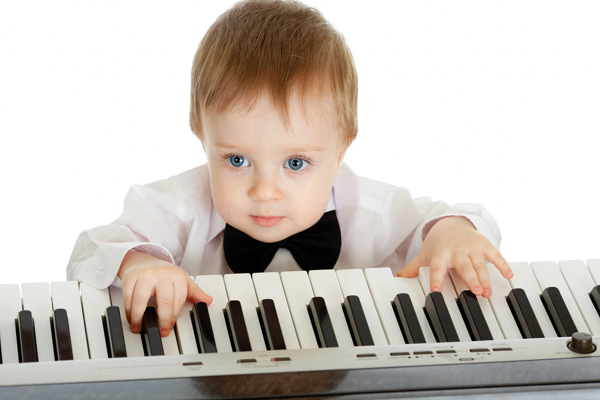 adorable child playing electronic piano