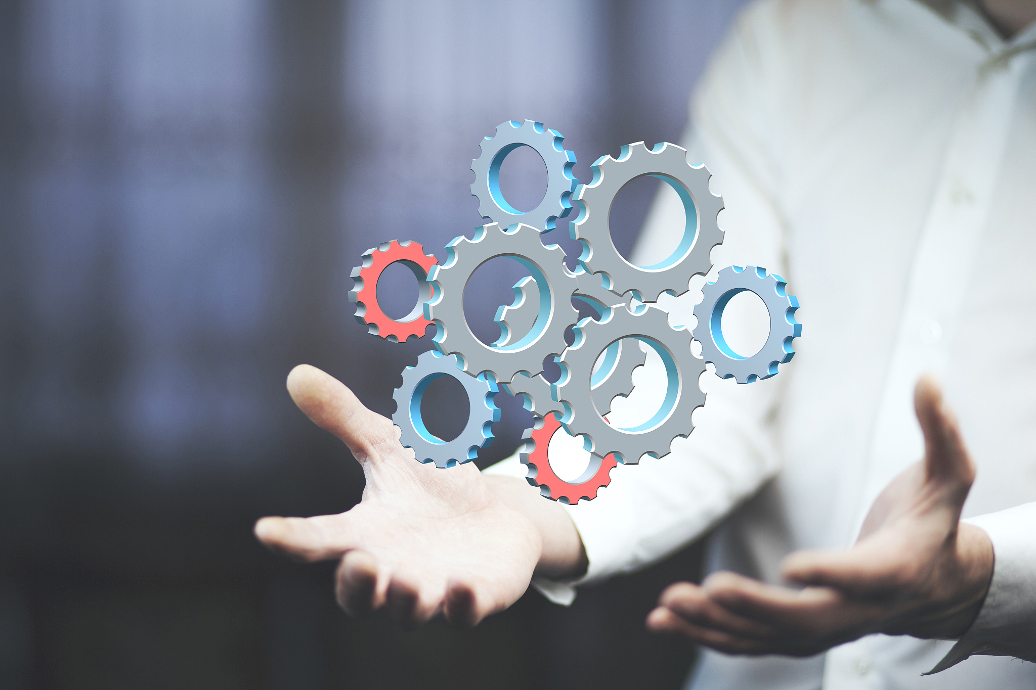 close up of businessman holding gears in palms