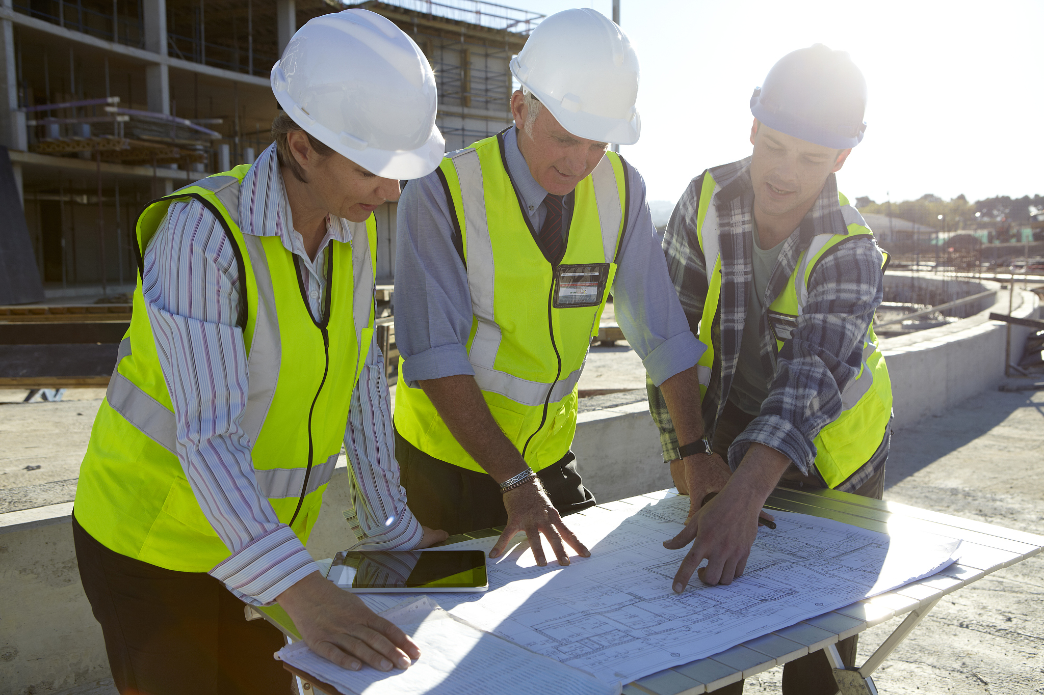 builders and architect looking at plans together