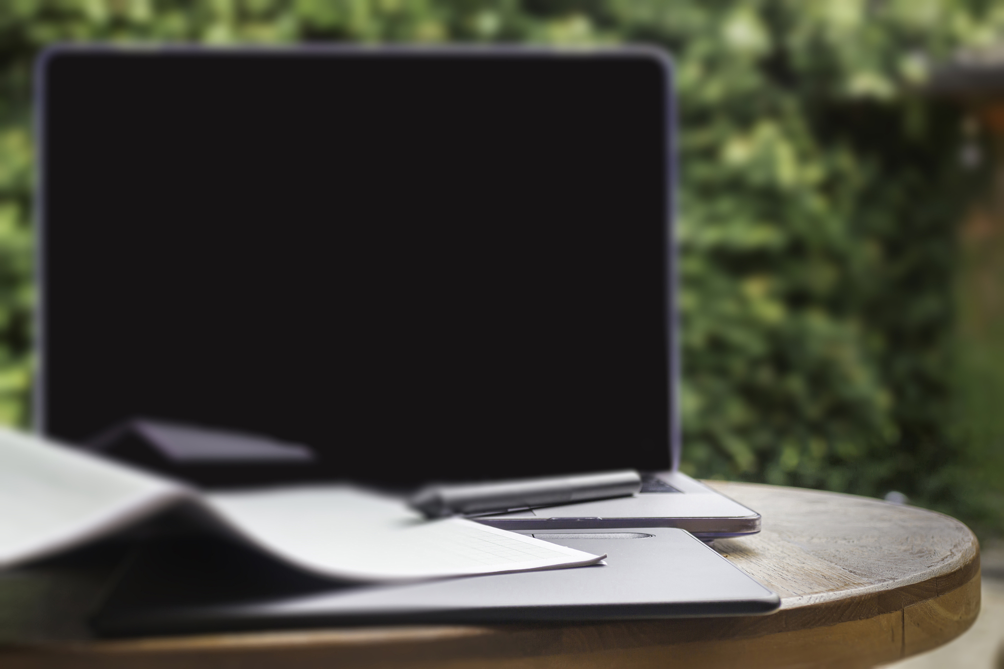 modern laptop computer on wooden table in home garden