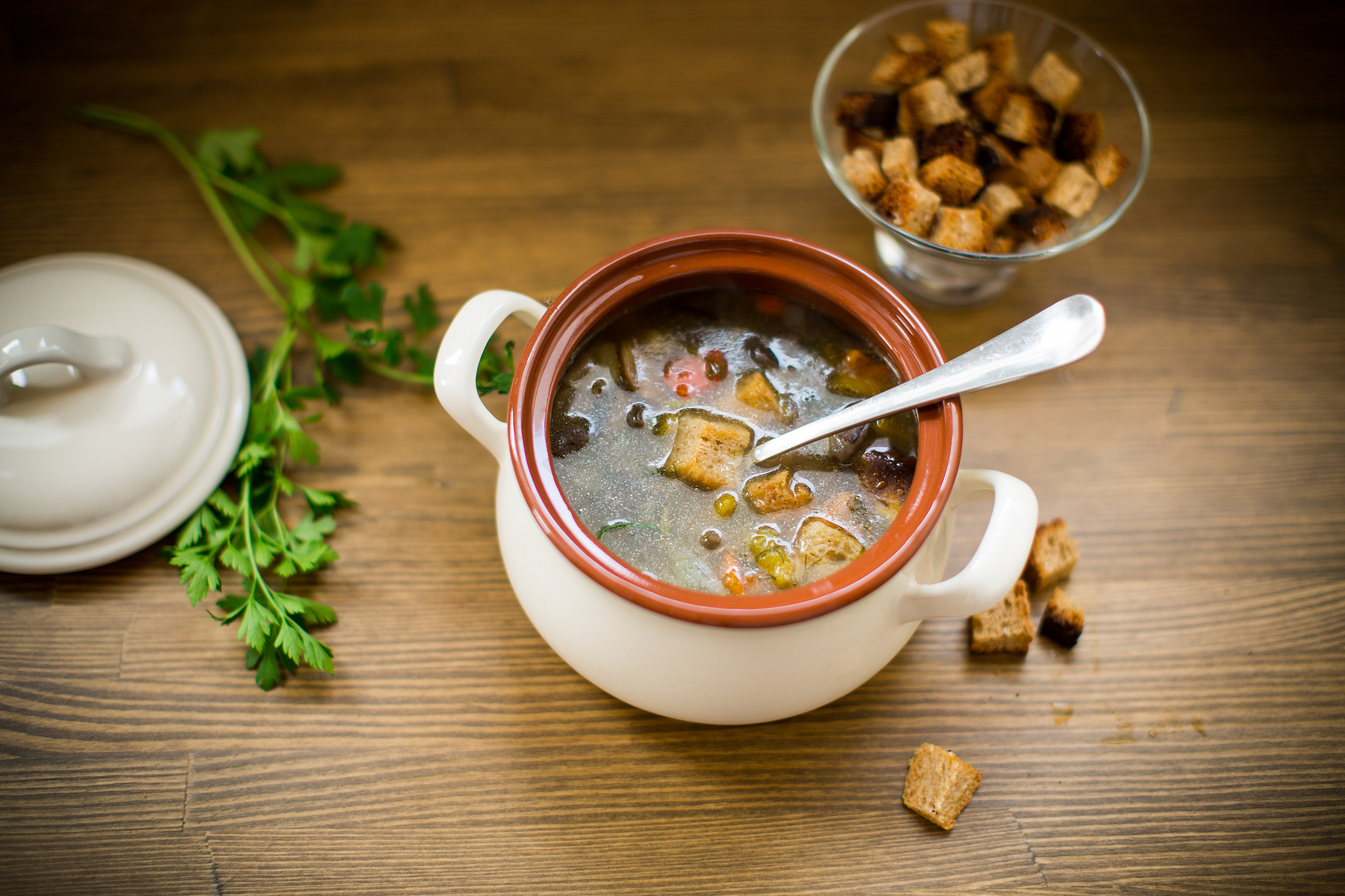 homemade vegetable soup with wild mushrooms and peppers in a pla