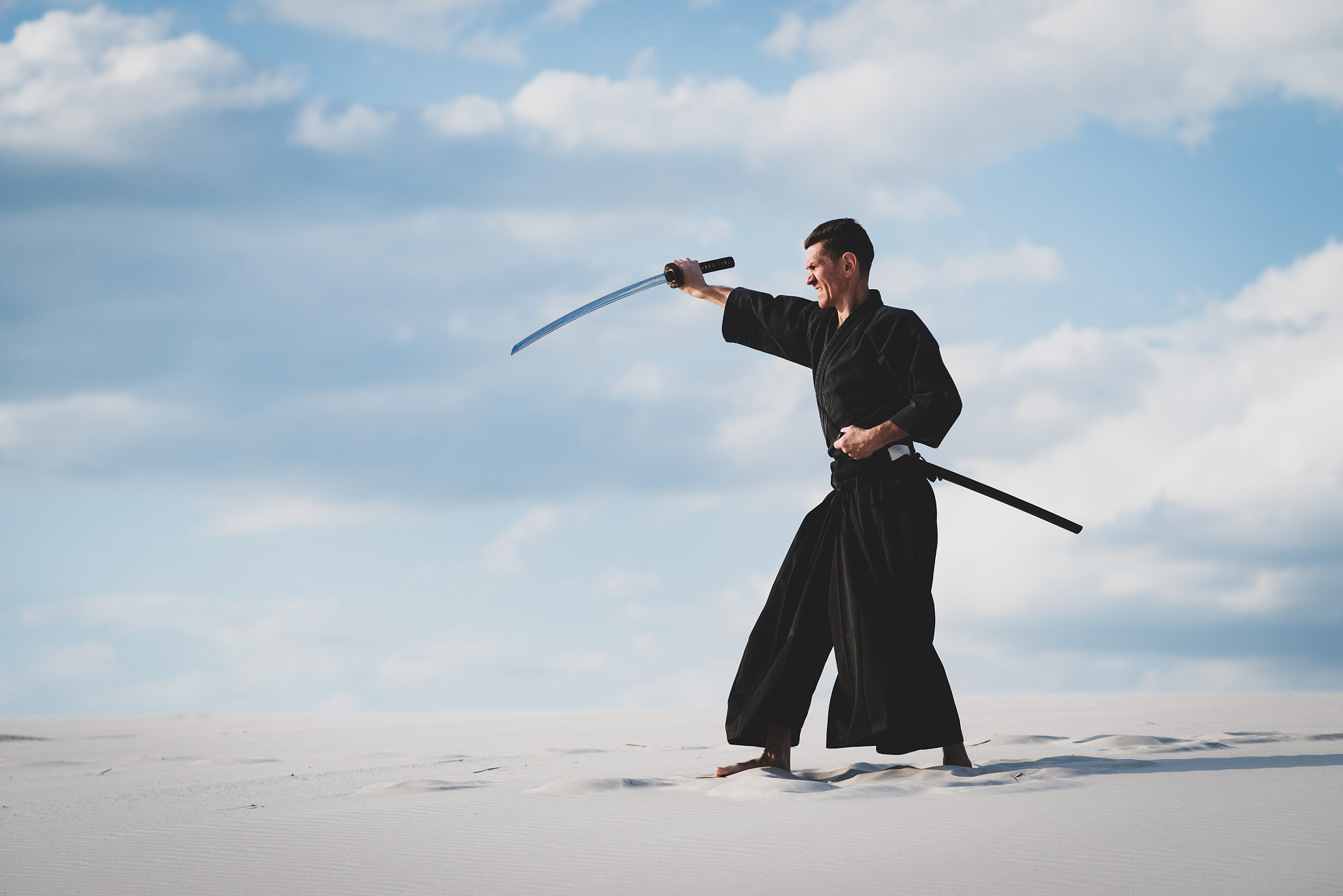 man training martial arts in desert